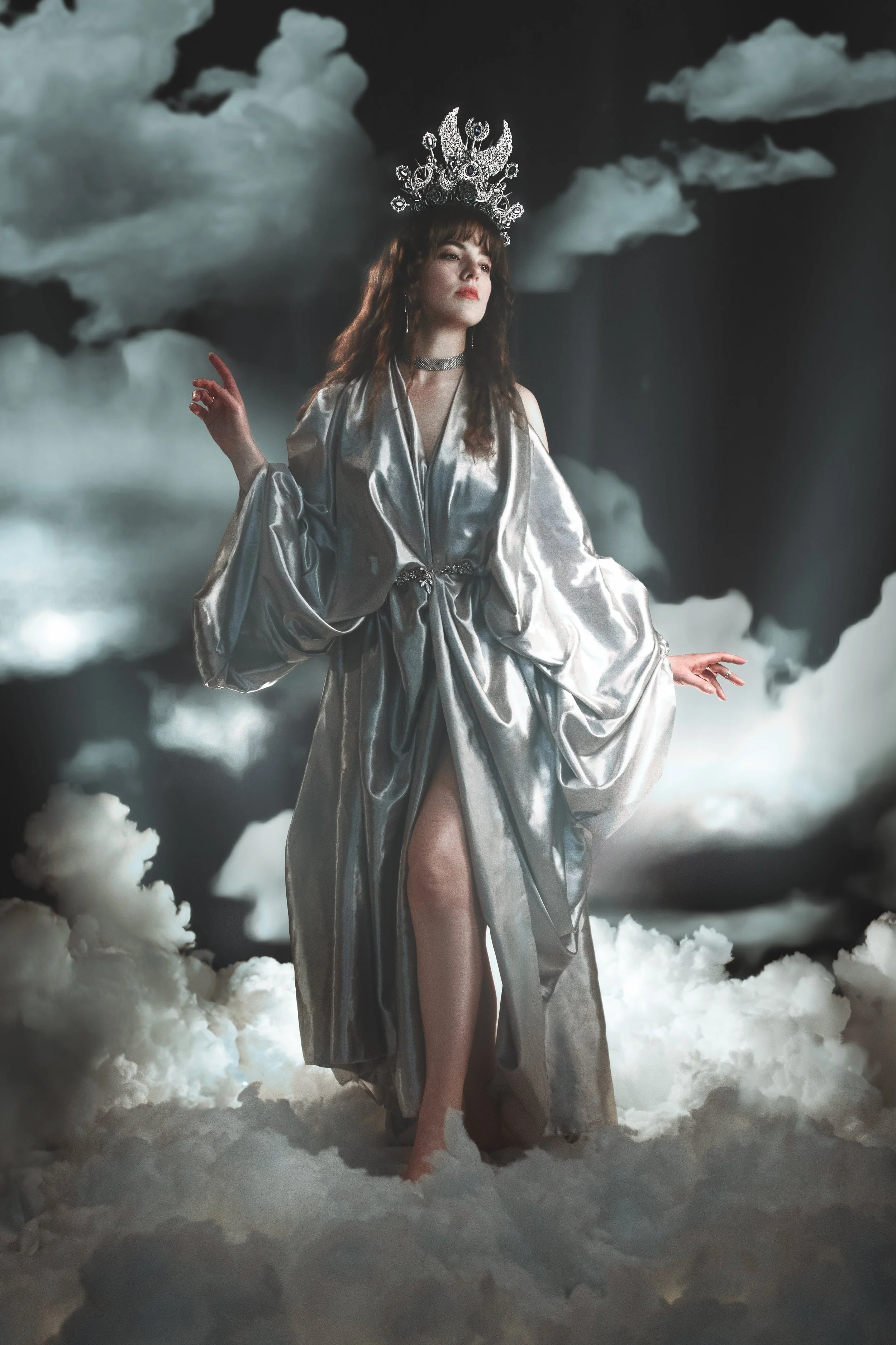 Fine art fantasy portrait of sun and moon goddesses with celestial crowns, clouds and dramatic light. Mythology inspired photography with golden and silver tones, painterly style and dreamy storytelling atmosphere.
