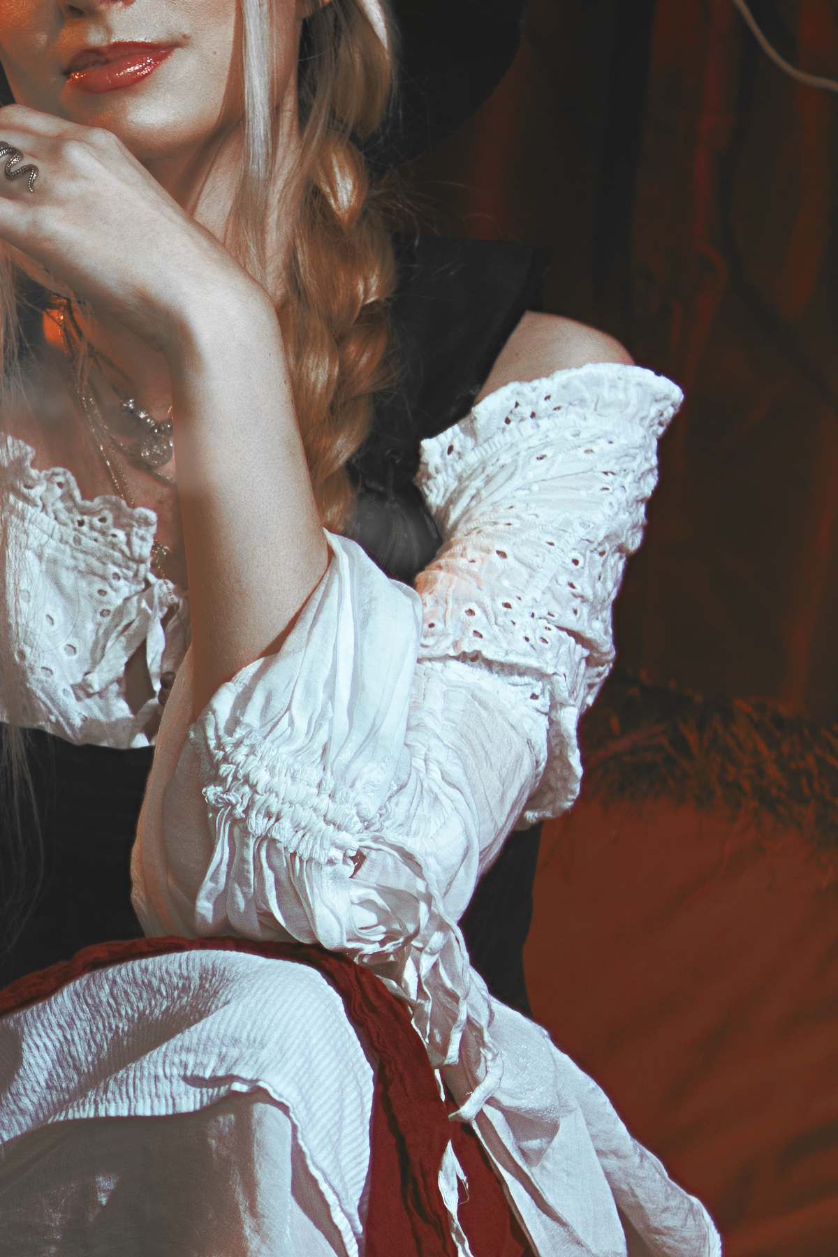 Pirate inspired cosplay portrait with sword and historical styling. Fine art fantasy photography influenced by seafaring adventures and vintage aesthetics, featuring warm light and a cinematic storytelling atmosphere.