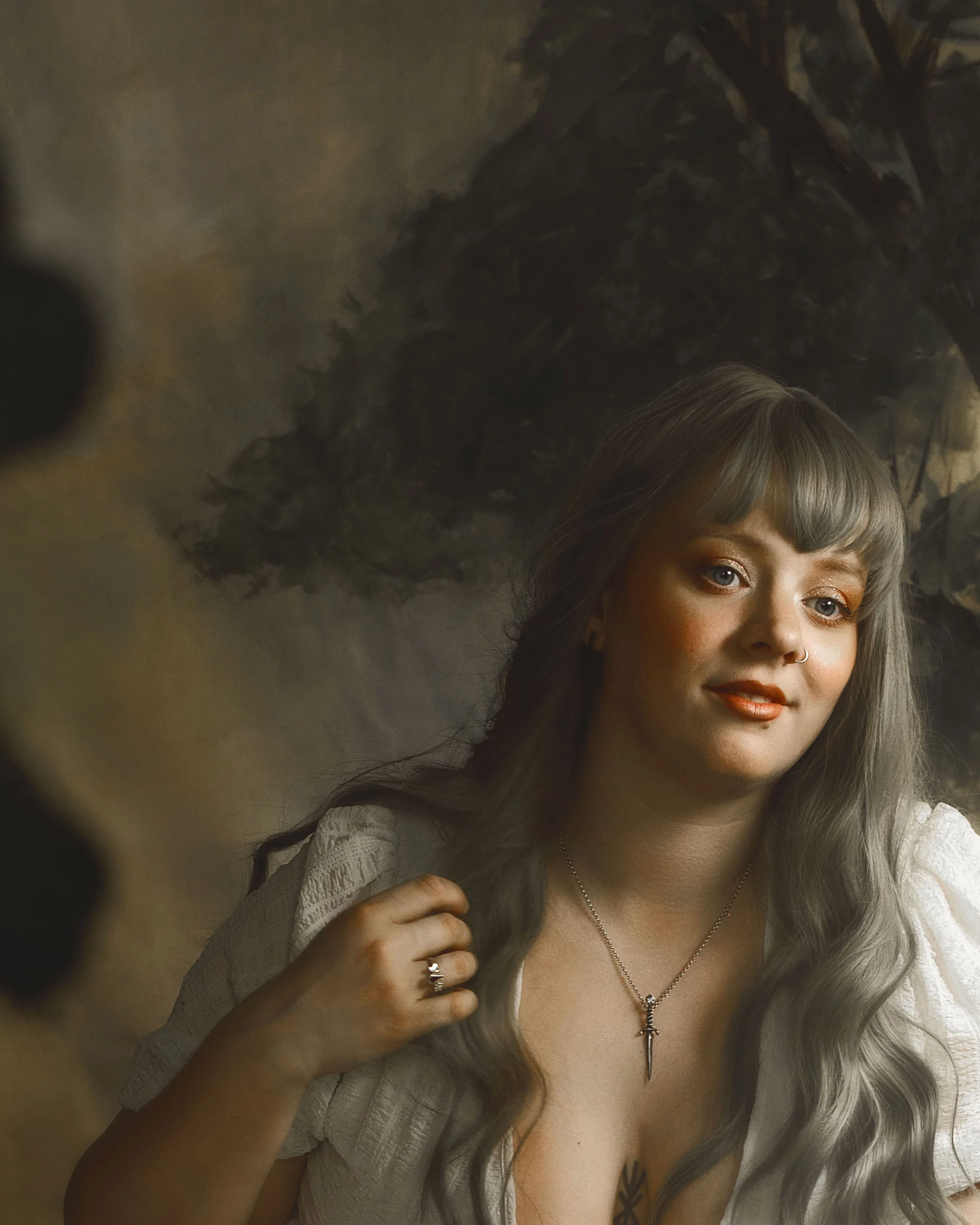 Dreamy fine art portrait of a woman in water surrounded by flowers and soft reflections. Painterly fantasy photography inspired by folklore, mythology and classical paintings. Romantic, ethereal imagery with storytelling atmosphere and natural elemen