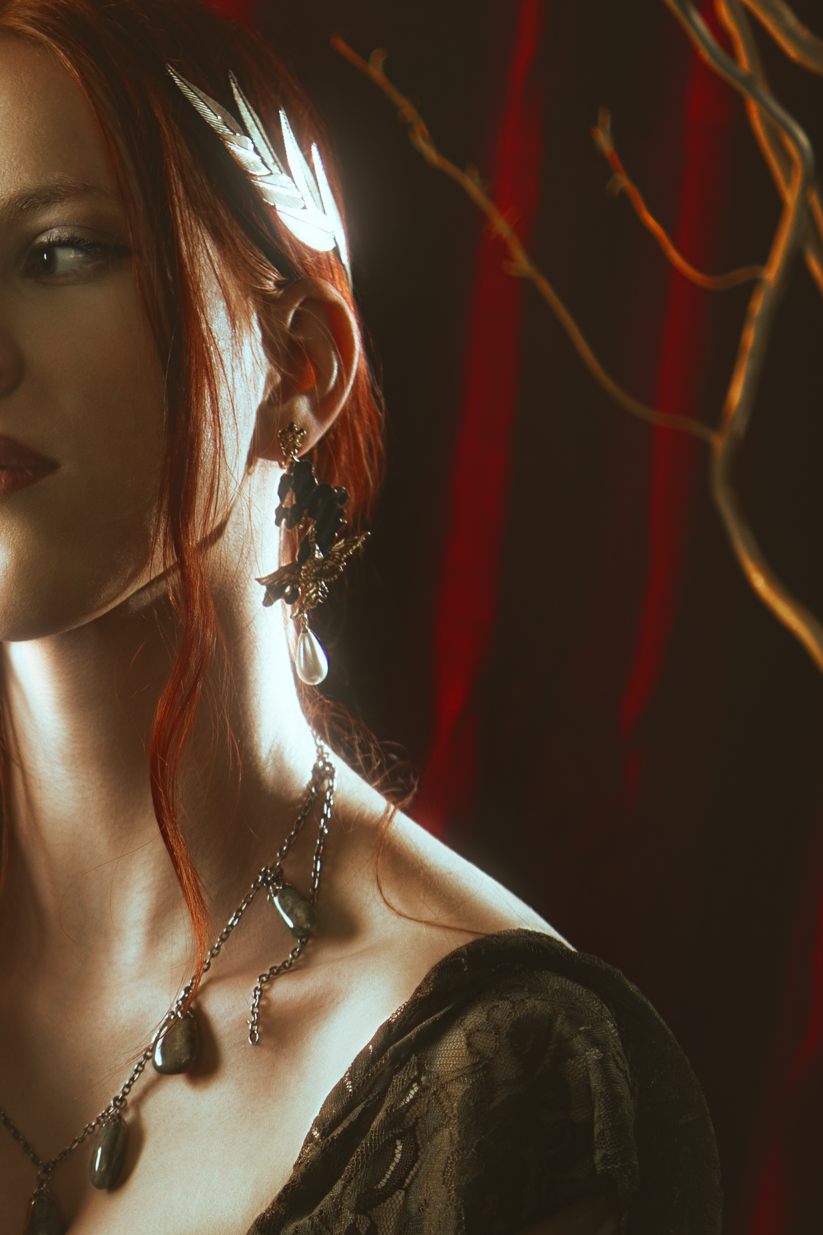 Persephone inspired dark goddess cosplay portrait with pomegranate, red velvet and candlelight. Fine art fantasy photography based on Greek mythology, featuring rich colors and a moody, storytelling atmosphere.