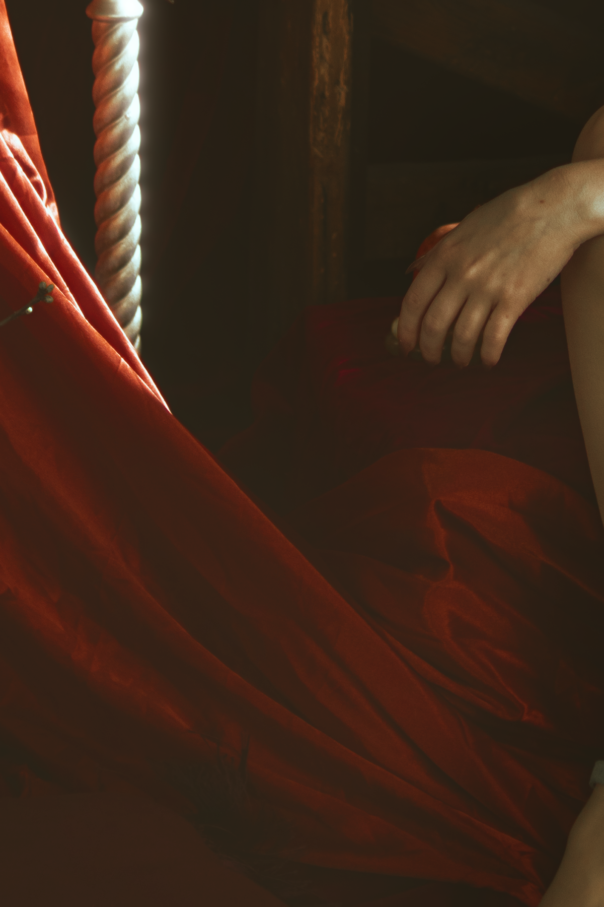 Persephone inspired dark goddess cosplay portrait with pomegranate, red velvet and candlelight. Fine art fantasy photography based on Greek mythology, featuring rich colors and a moody, storytelling atmosphere.