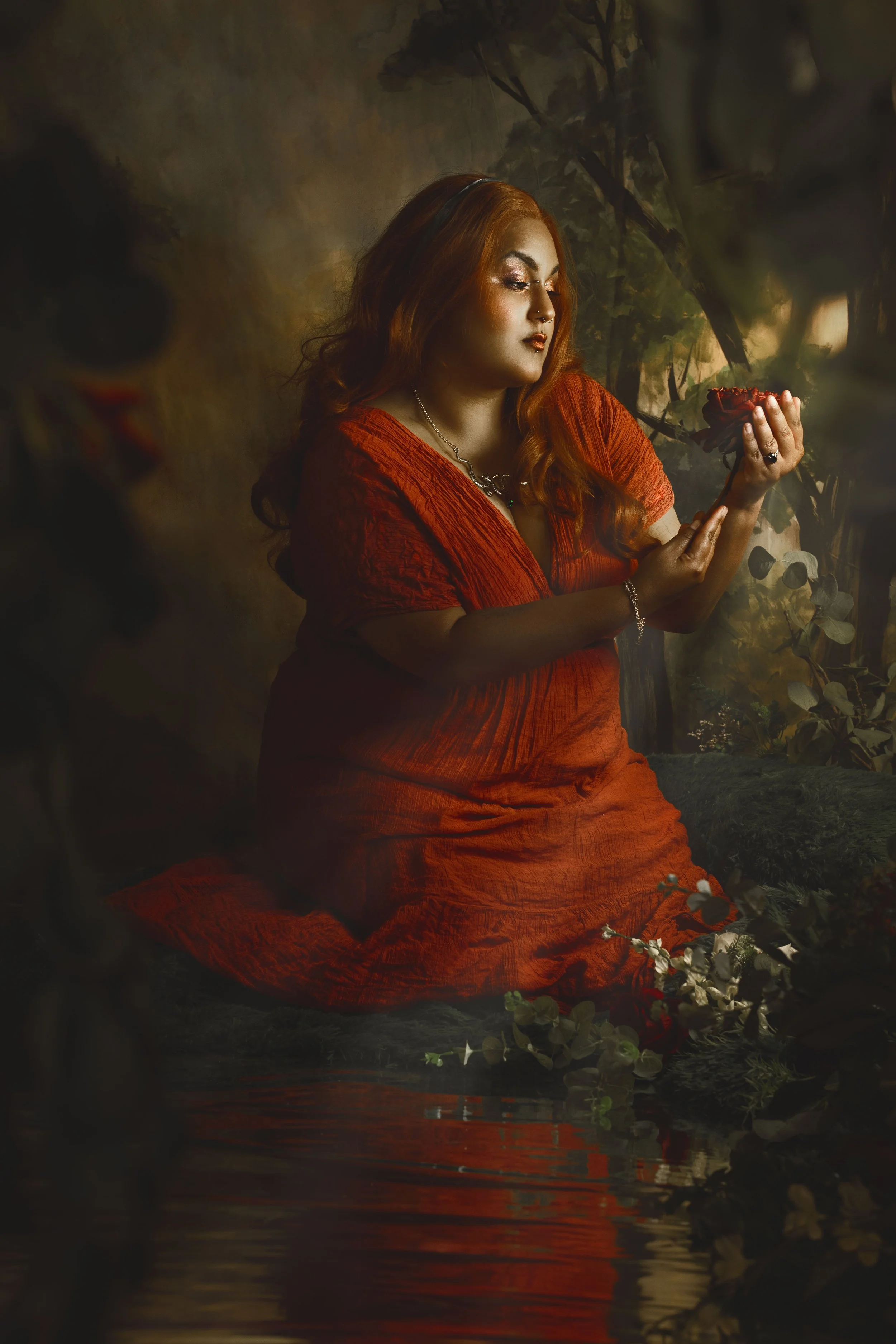 Dreamy fine art portrait of a woman in water surrounded by flowers and soft reflections. Painterly fantasy photography inspired by folklore, mythology and classical paintings. Romantic, ethereal imagery with storytelling atmosphere and natural elemen