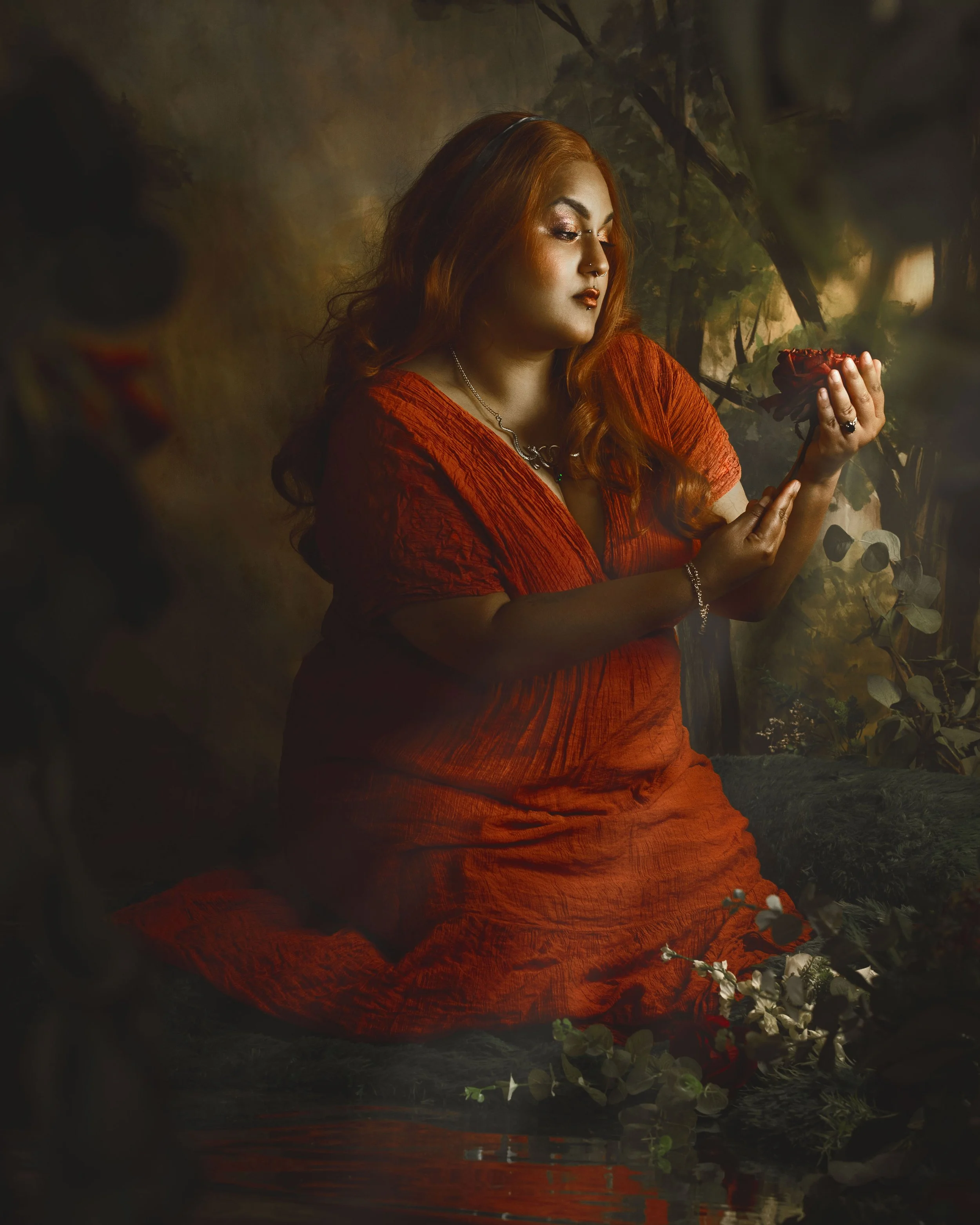 Dreamy fine art portrait of a woman in water surrounded by flowers and soft reflections. Painterly fantasy photography inspired by folklore, mythology and classical paintings. Romantic, ethereal imagery with storytelling atmosphere and natural elemen