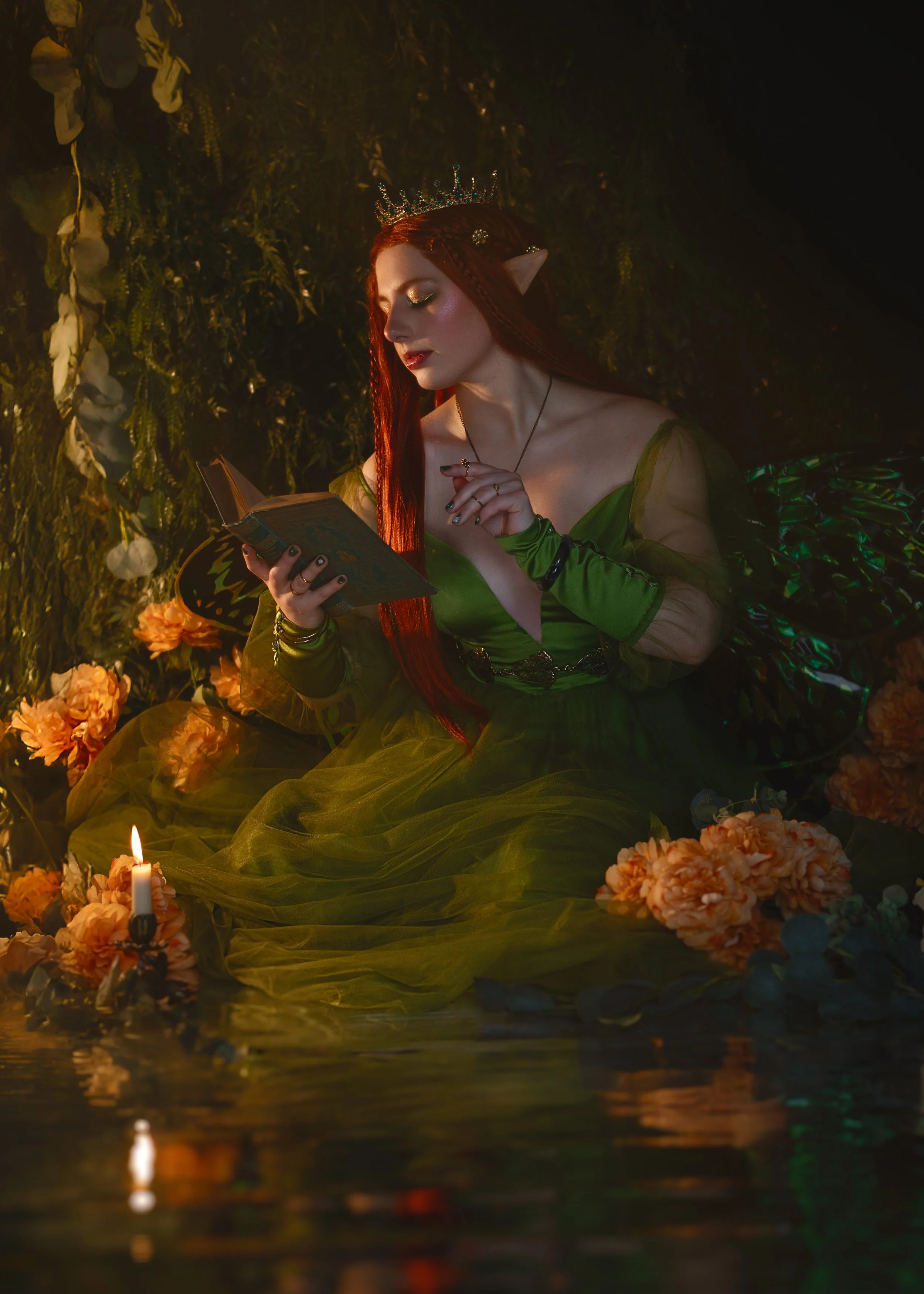 Dreamy fine art portrait of Natasha as a forest nymph surrounded by water, flowers and candlelight. Painterly fantasy photography inspired by folklore and nature mythology, featuring rich green tones and soft golden light.