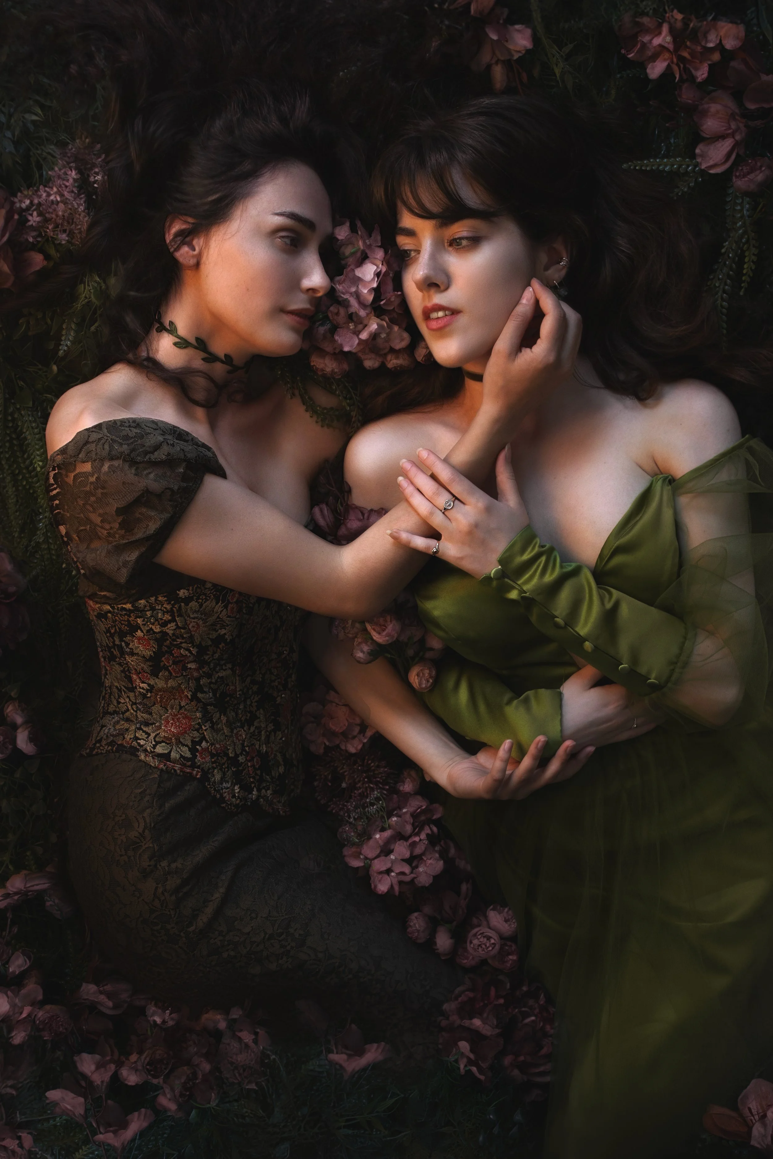 Dreamy fine art portraits of Mia and Talitha in a floral setting with rich green tones and romantic styling. Painterly fantasy photography inspired by classical art, nature and feminine storytelling. Intimate, emotional imagery with soft light, flowe