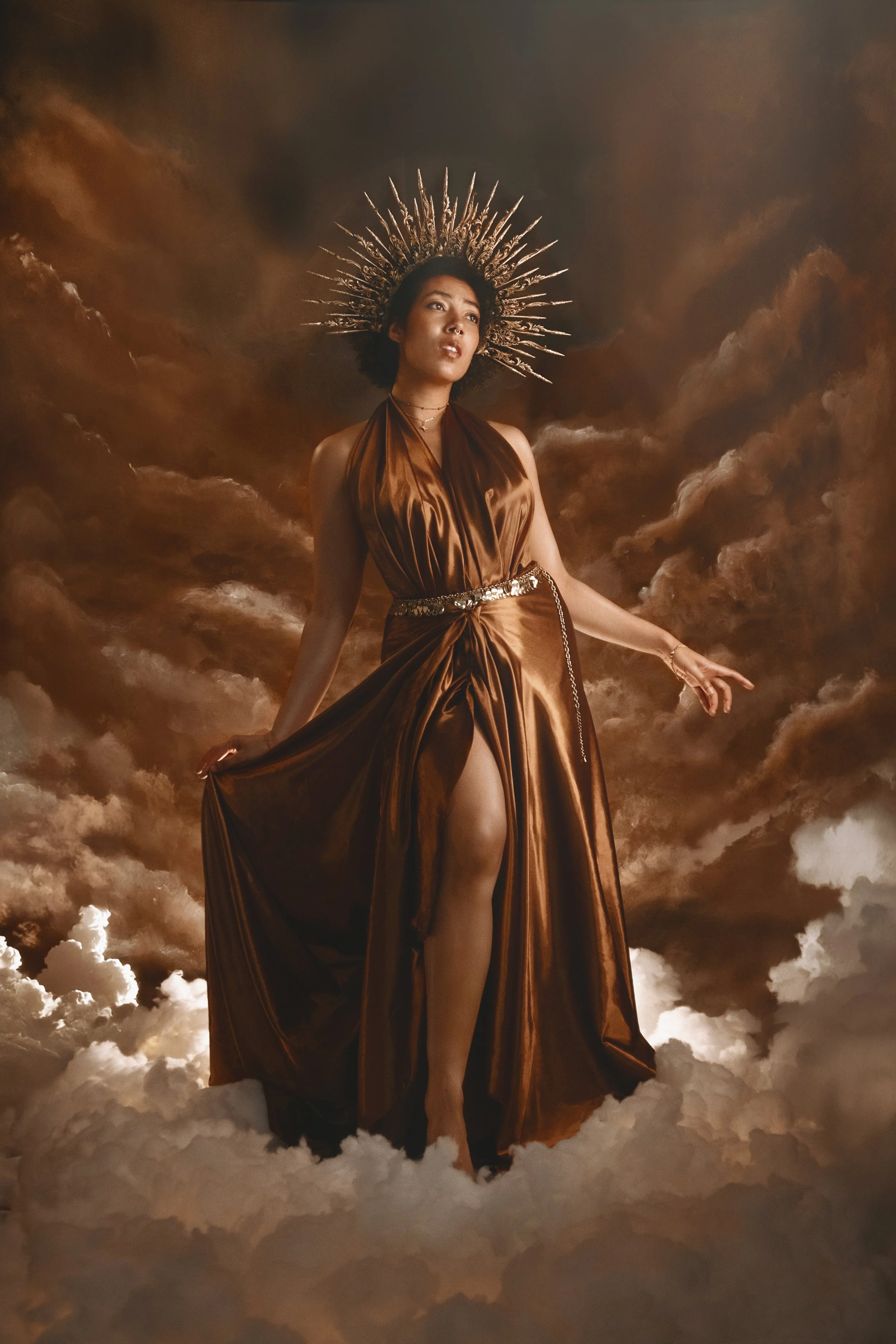 Fine art fantasy portrait of sun and moon goddesses with celestial crowns, clouds and dramatic light. Mythology inspired photography with golden and silver tones, painterly style and dreamy storytelling atmosphere.