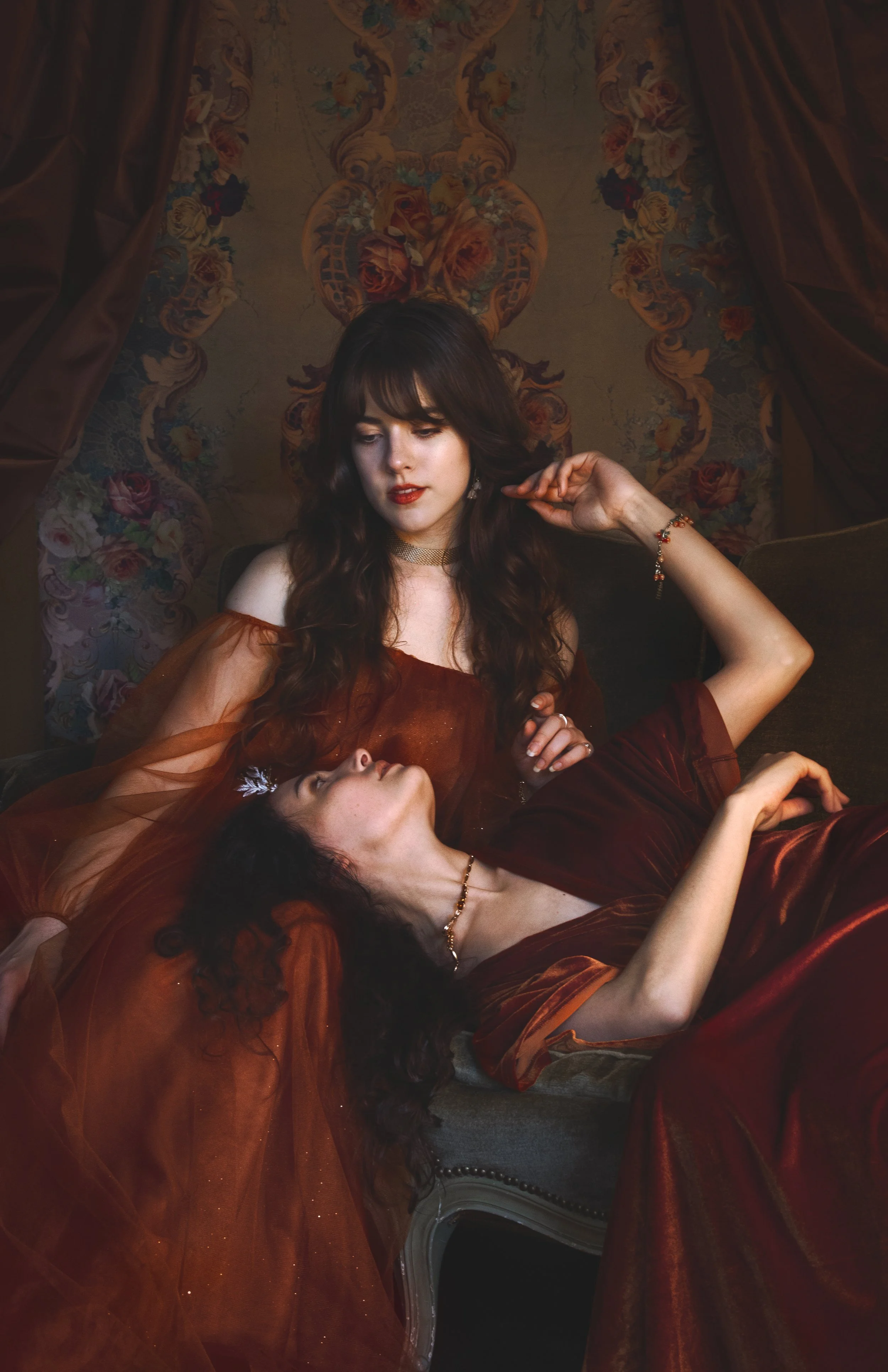 Dreamy fine art portraits of Mia and Talitha in a floral setting with rich green tones and romantic styling. Painterly fantasy photography inspired by classical art, nature and feminine storytelling. Intimate, emotional imagery with soft light, flowe