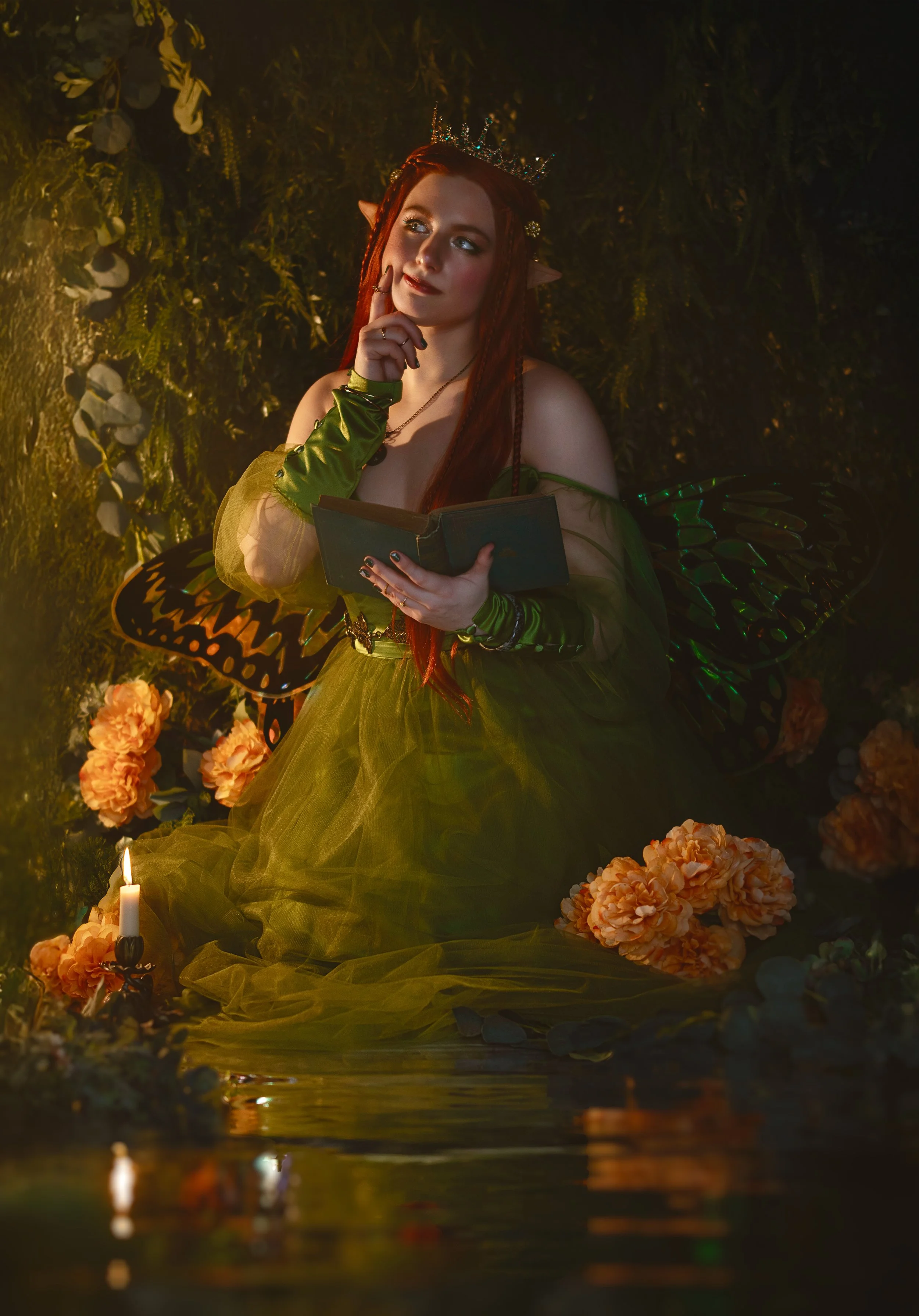 Dreamy fine art portrait of Natasha as a forest nymph surrounded by water, flowers and candlelight. Painterly fantasy photography inspired by folklore and nature mythology, featuring rich green tones and soft golden light.