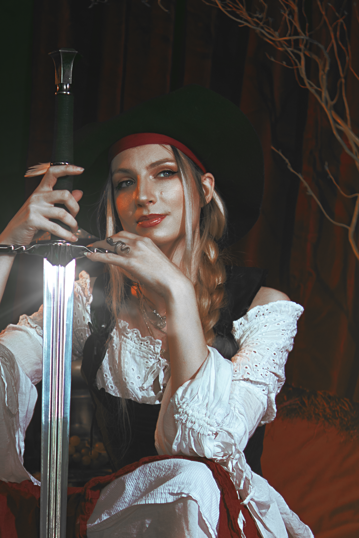 Pirate inspired cosplay portrait with sword and historical styling. Fine art fantasy photography influenced by seafaring adventures and vintage aesthetics, featuring warm light and a cinematic storytelling atmosphere.