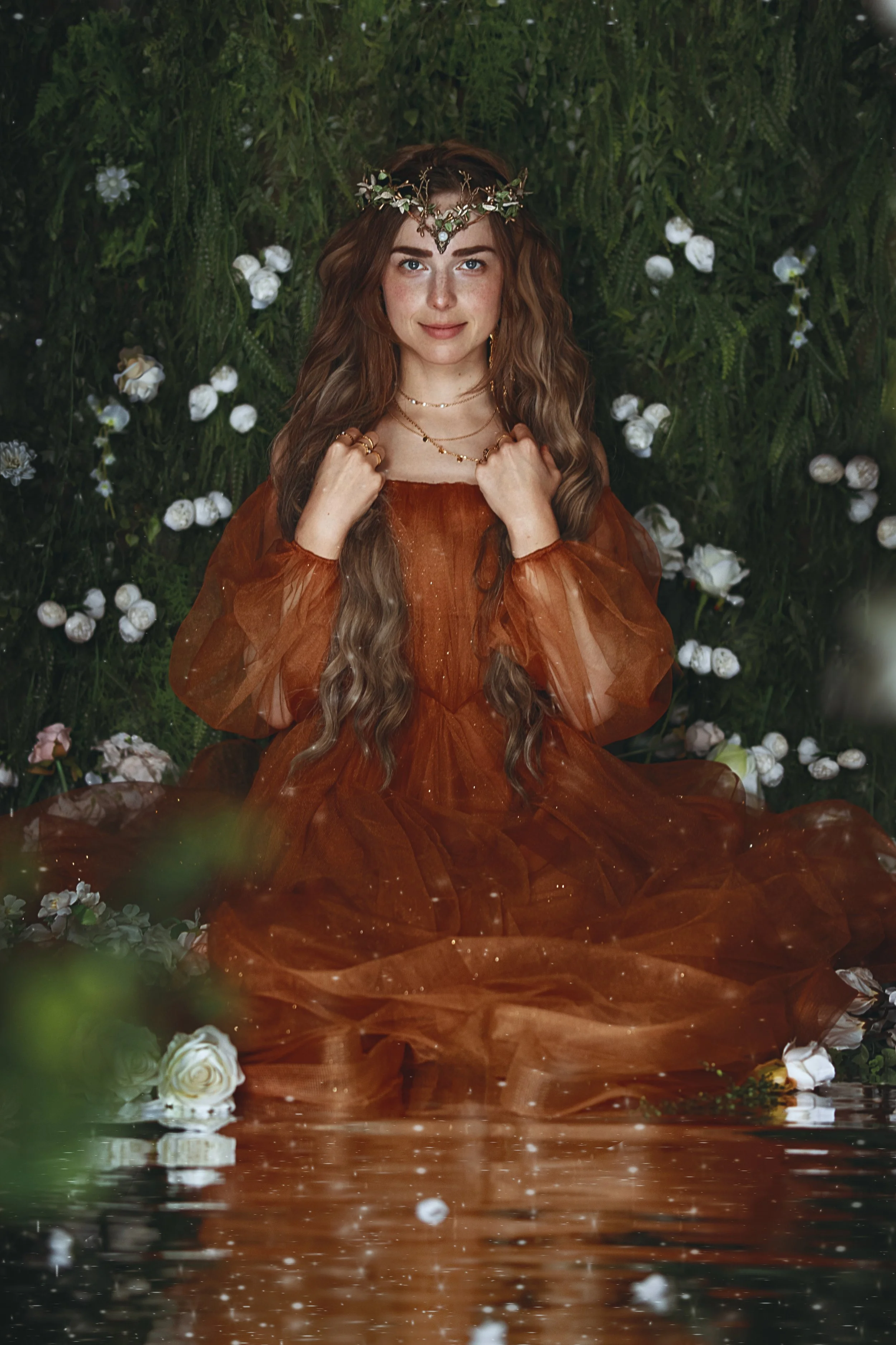 Dreamy fine art portrait of a flower nymph in water surrounded by blossoms and greenery. Ethereal fantasy photography inspired by folklore, mythology and nature. Painterly, romantic imagery with soft light, floral details and storytelling atmosphere.