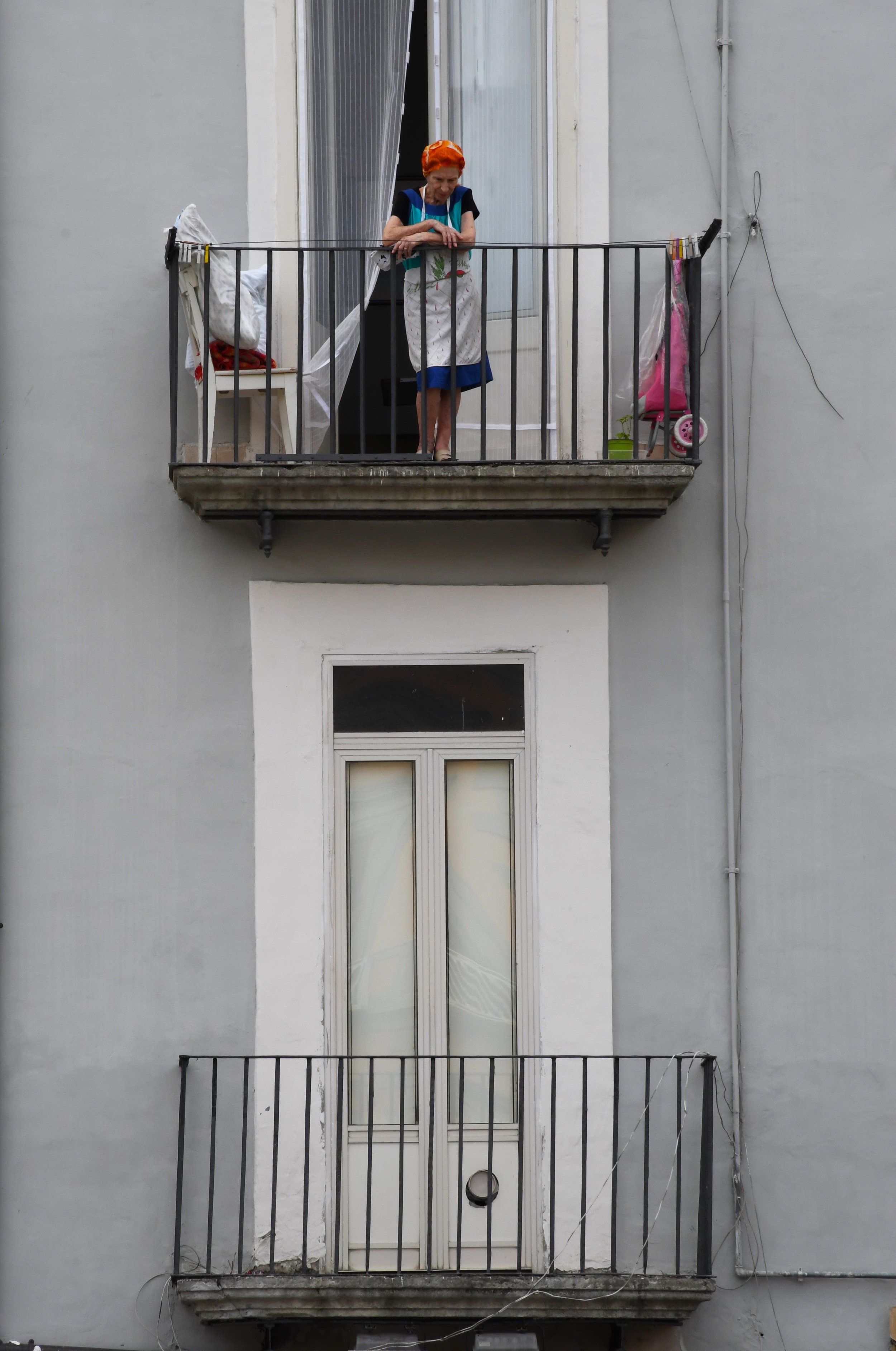 Woman on balcony, Naples, Italy.