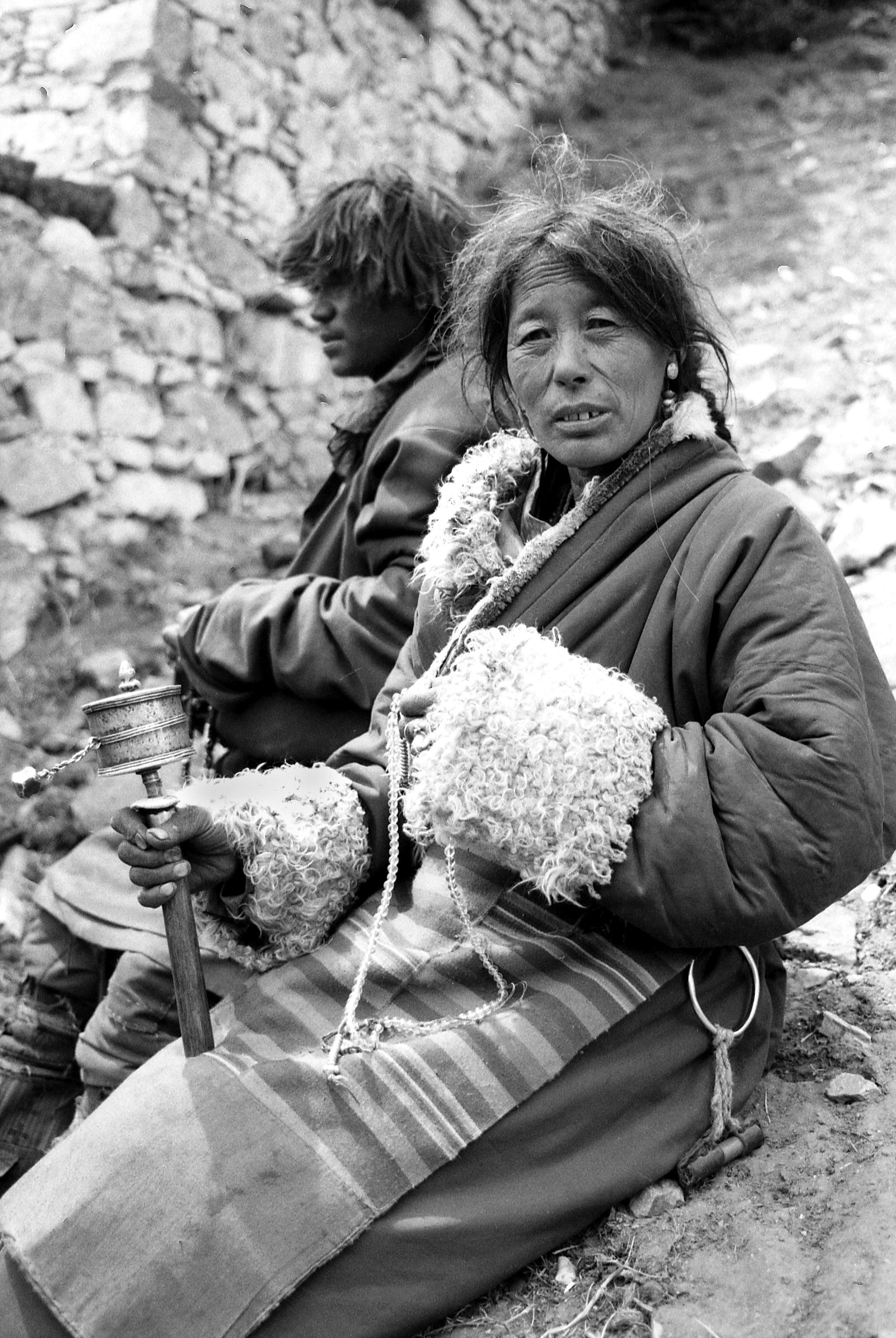 Tibetan woman with prayer wheel. Tibet