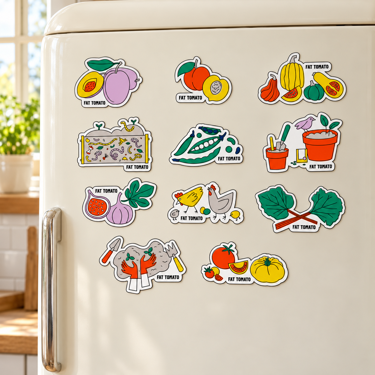 Colourful Fat Tomato magnets displayed on a cream kitchen fridge.