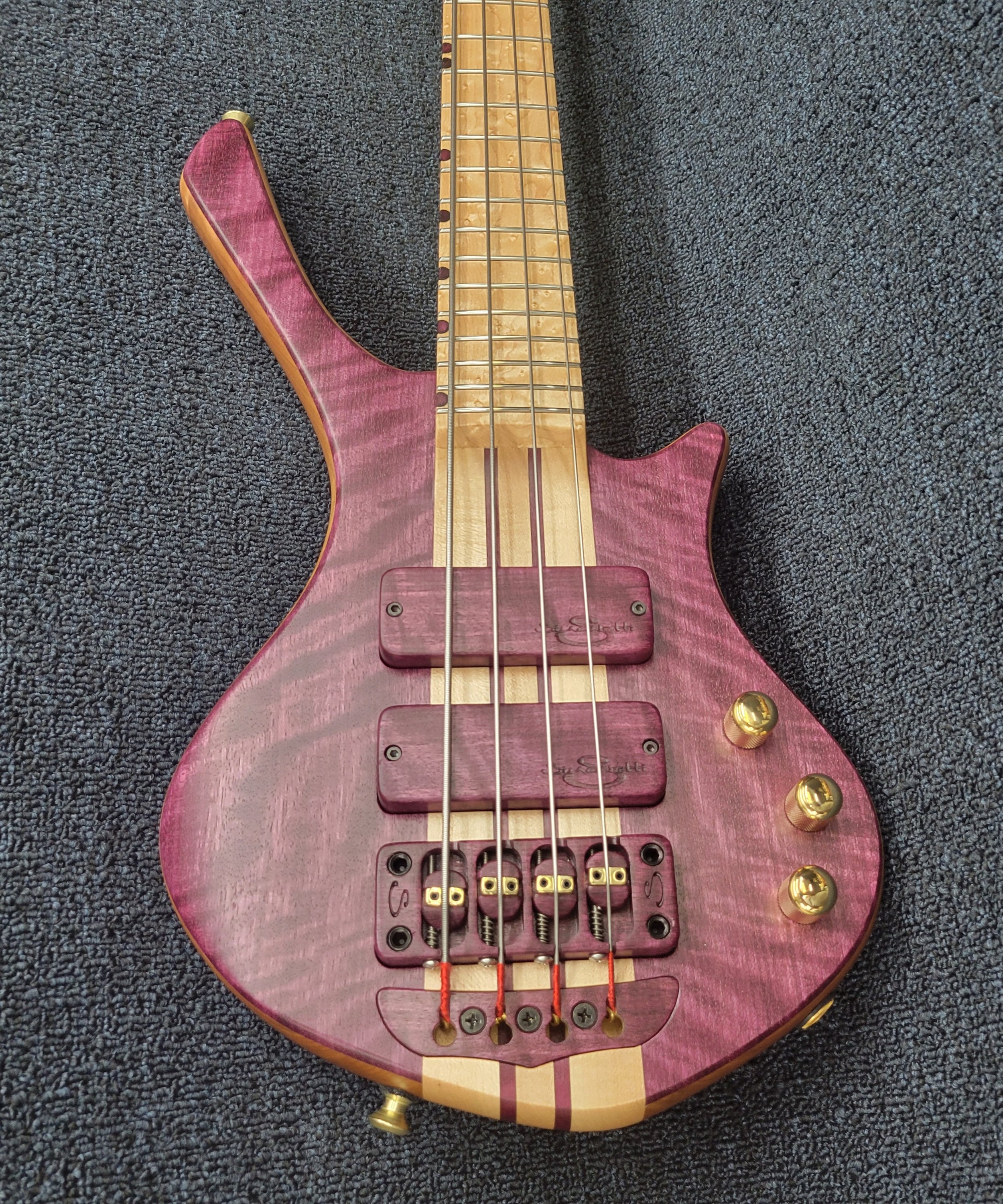 Simonetti 4 string bass in a custom Exotic design with figured purpleheart top, Birdseye Maple fingerboard and neck through body construction.