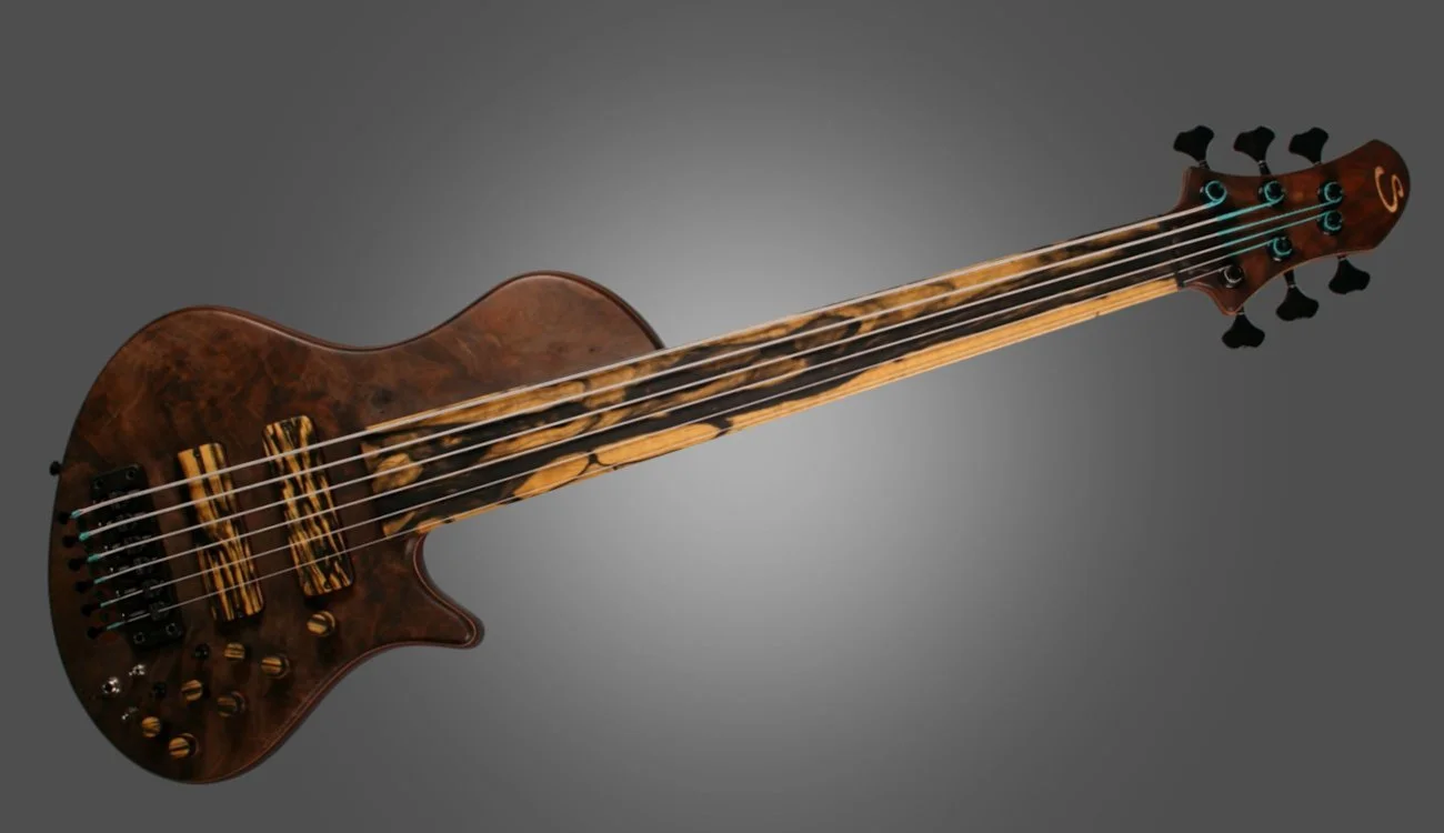 A unique stringed instrument combining features of a guitar and a bass, with a wooden body, multiple strings, and tuning pegs.