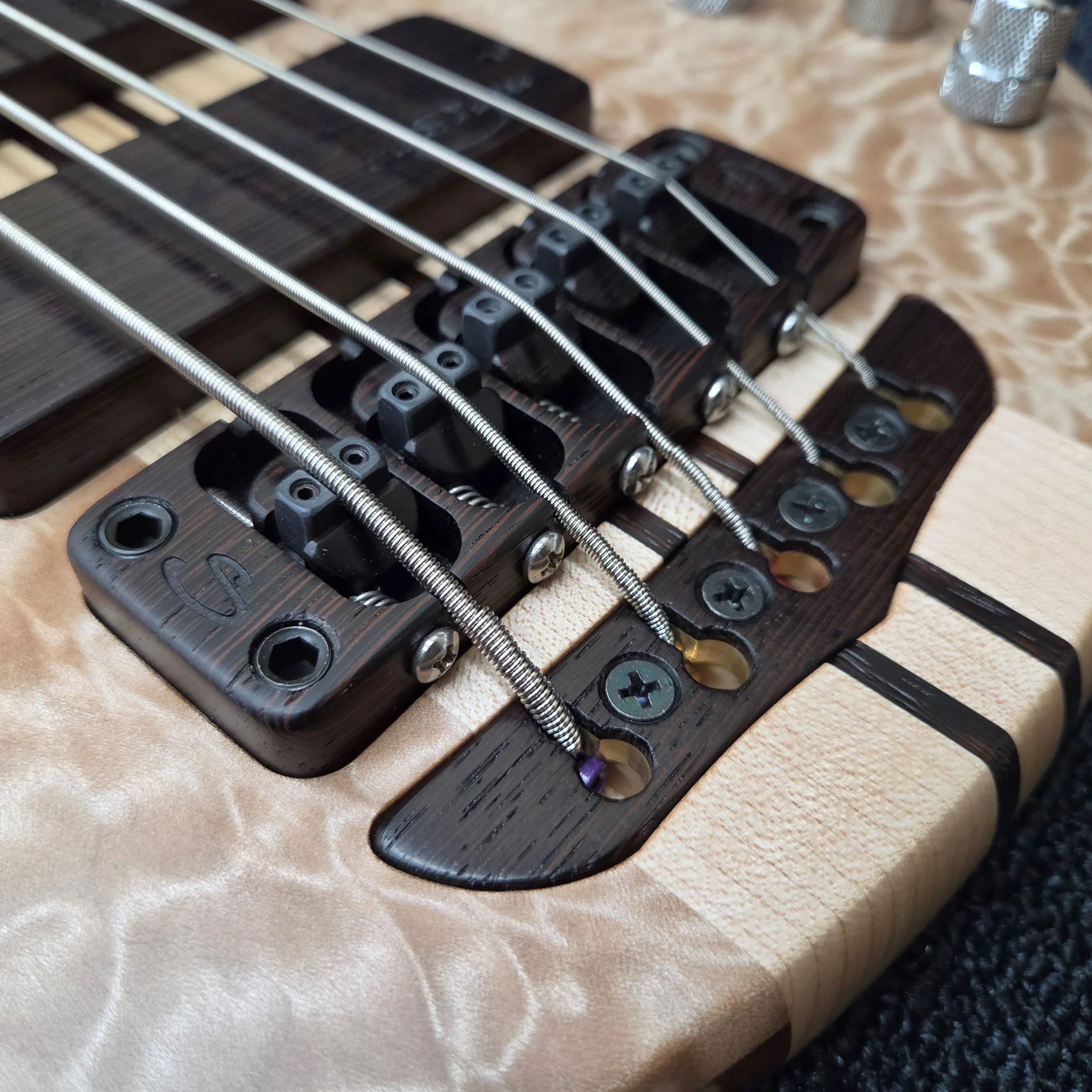 Simonetti 4-way bridge system allows for individual string height, string spacing, intonation and overall height adjustment. The wood capped brass tail sits flush with the body to give the strings a solid anchor point. The bridge sits on a 3/16" bras