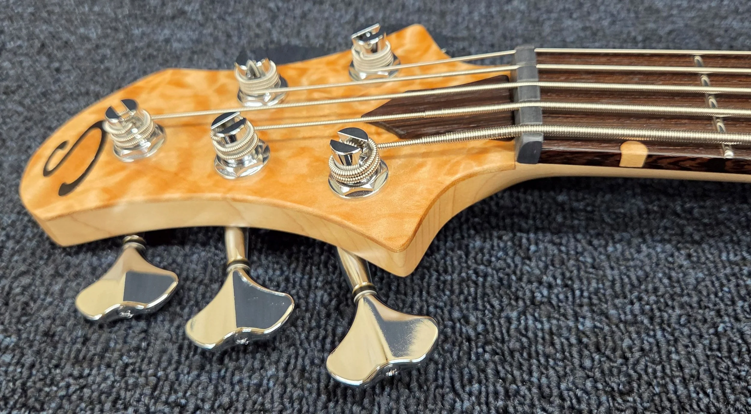 The head tilts back at an 8-degree angle enough for good string tension on the nut but not so much to make the head brittle 