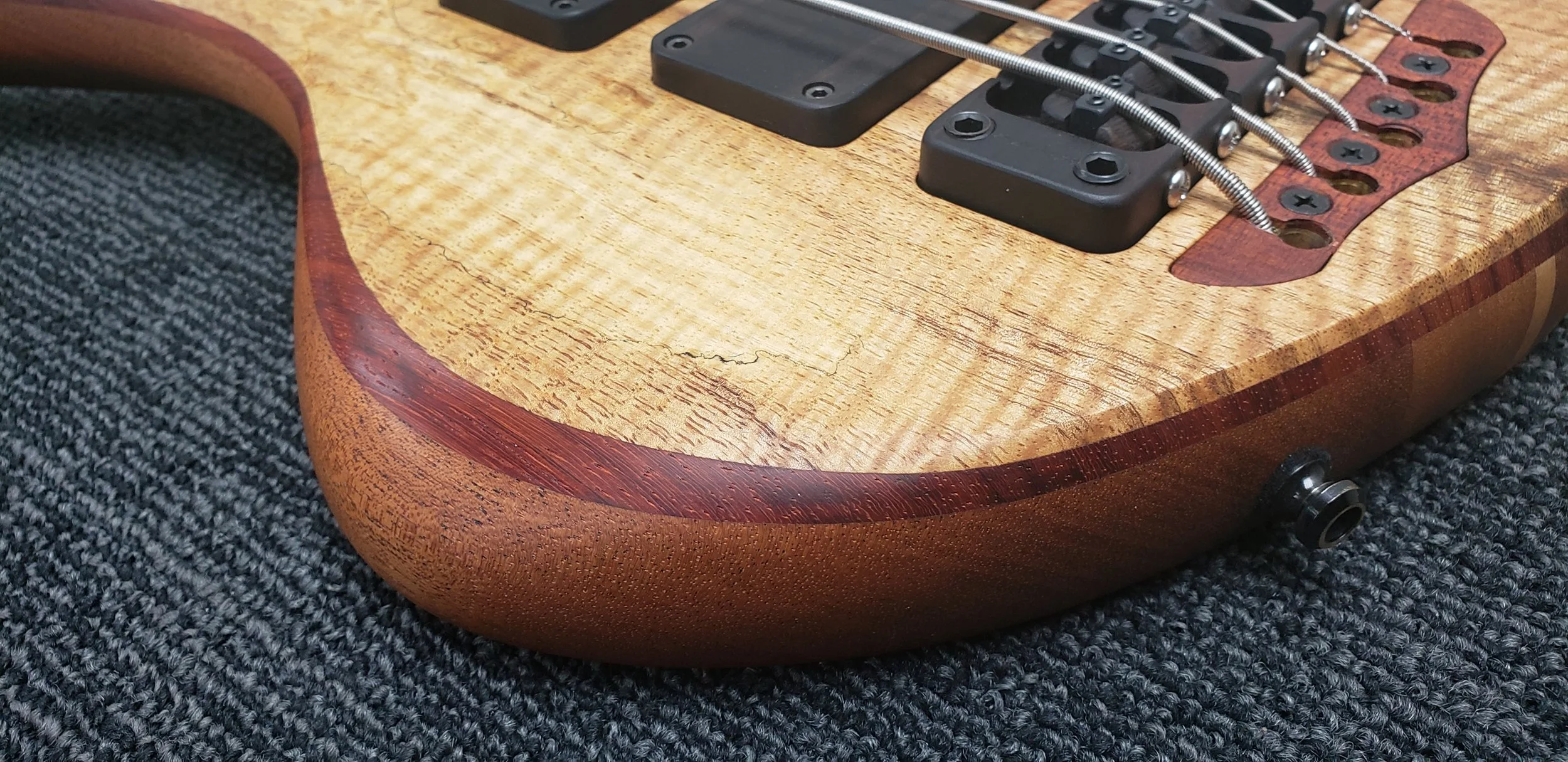 Contrasting layer and forearm details on a Simonetti Basses 5 string bass