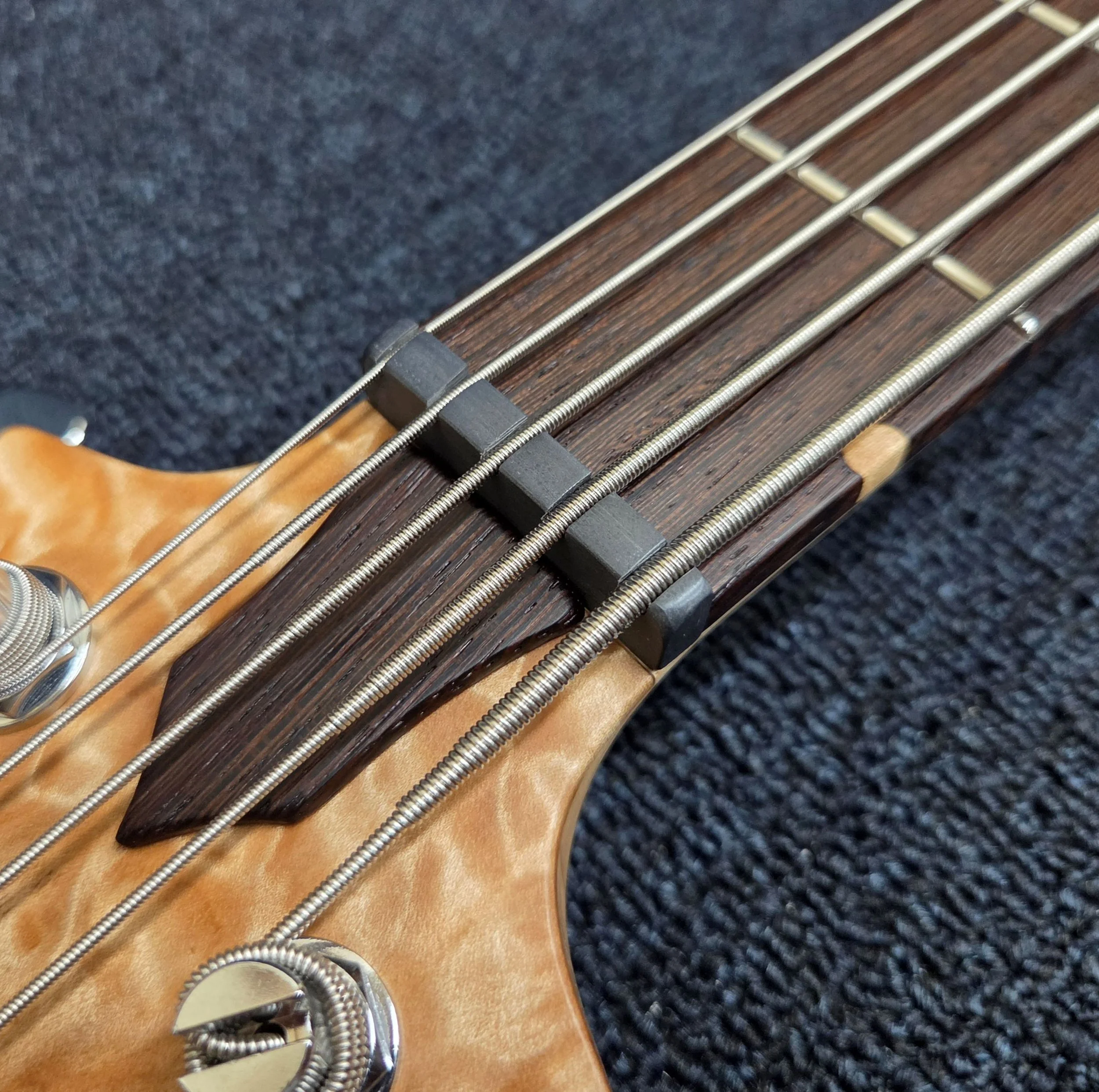 The Graph Tech Tusq nut is hand shaped and slotted for even string spacing