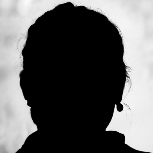 Silhouette of a person's head and shoulders facing away from the camera