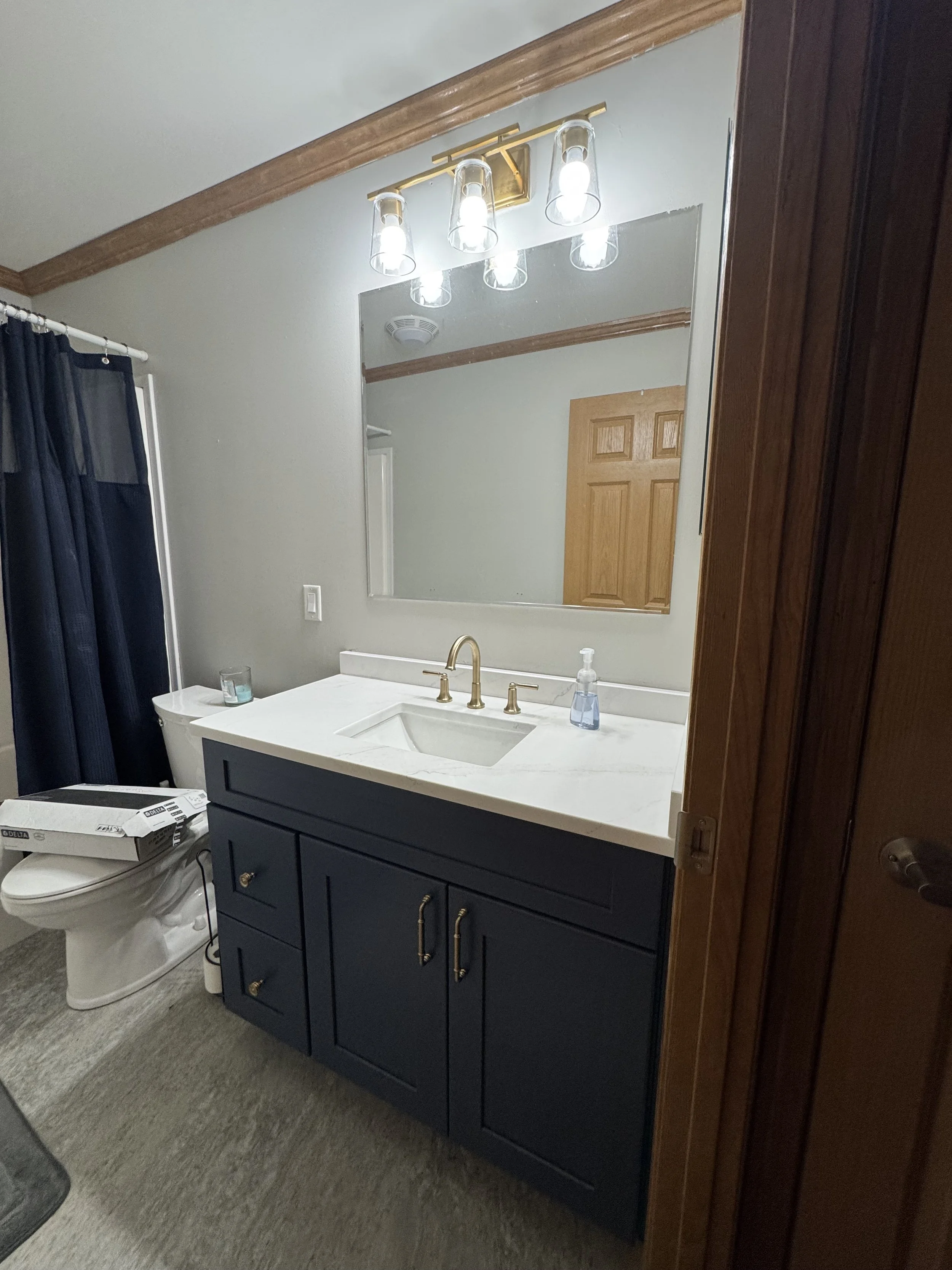 First Floor Remodel - Bathroom - Spring 2025 - Ocean Blue and White cabinetry, Shaw LVP flooring, MSI Quartz, Tile backsplash, Delta Touch Faucet