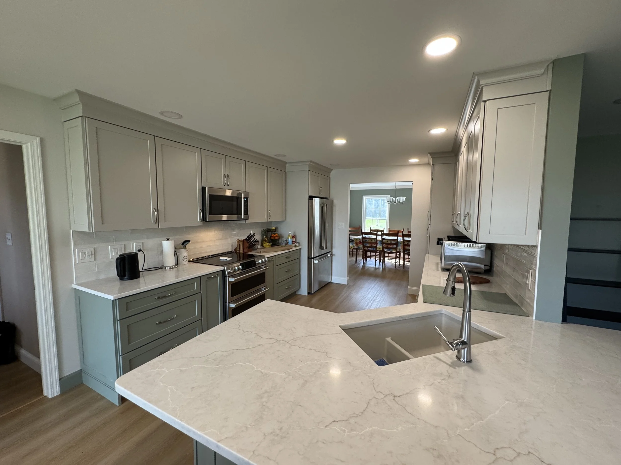 First Floor Remodel - Spring 2025 - Legend Cabinetry, Calacatta Miraggio Cove Quartz, Tile backsplash, MSI Valleyview Grove flooring 