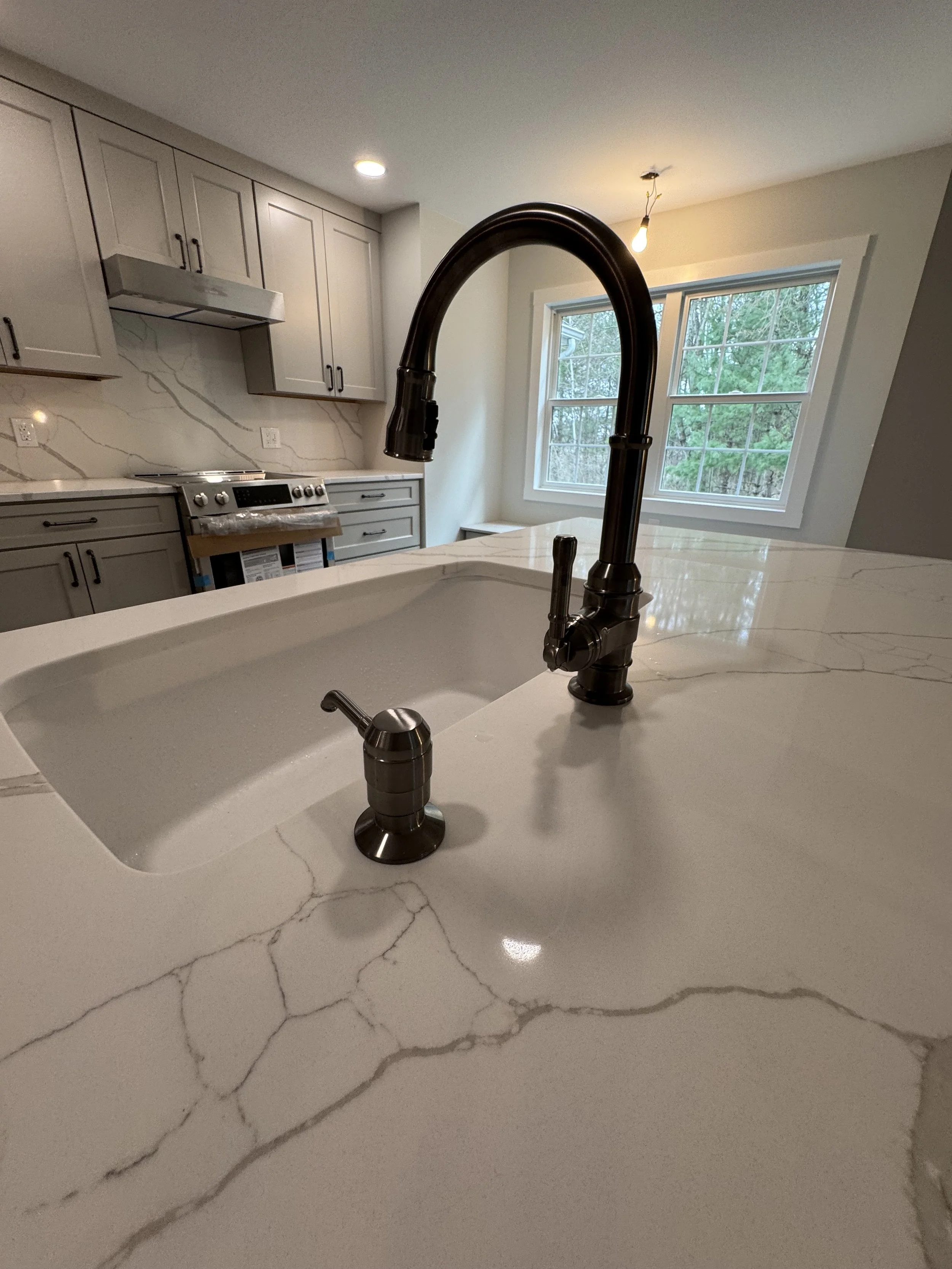 Kitchen Remodel - Spring 2025 - Legend Cabinetry Denali Pebble, Pental Quartz countertop and full height backsplash, Delta Broderick black stainless faucet  