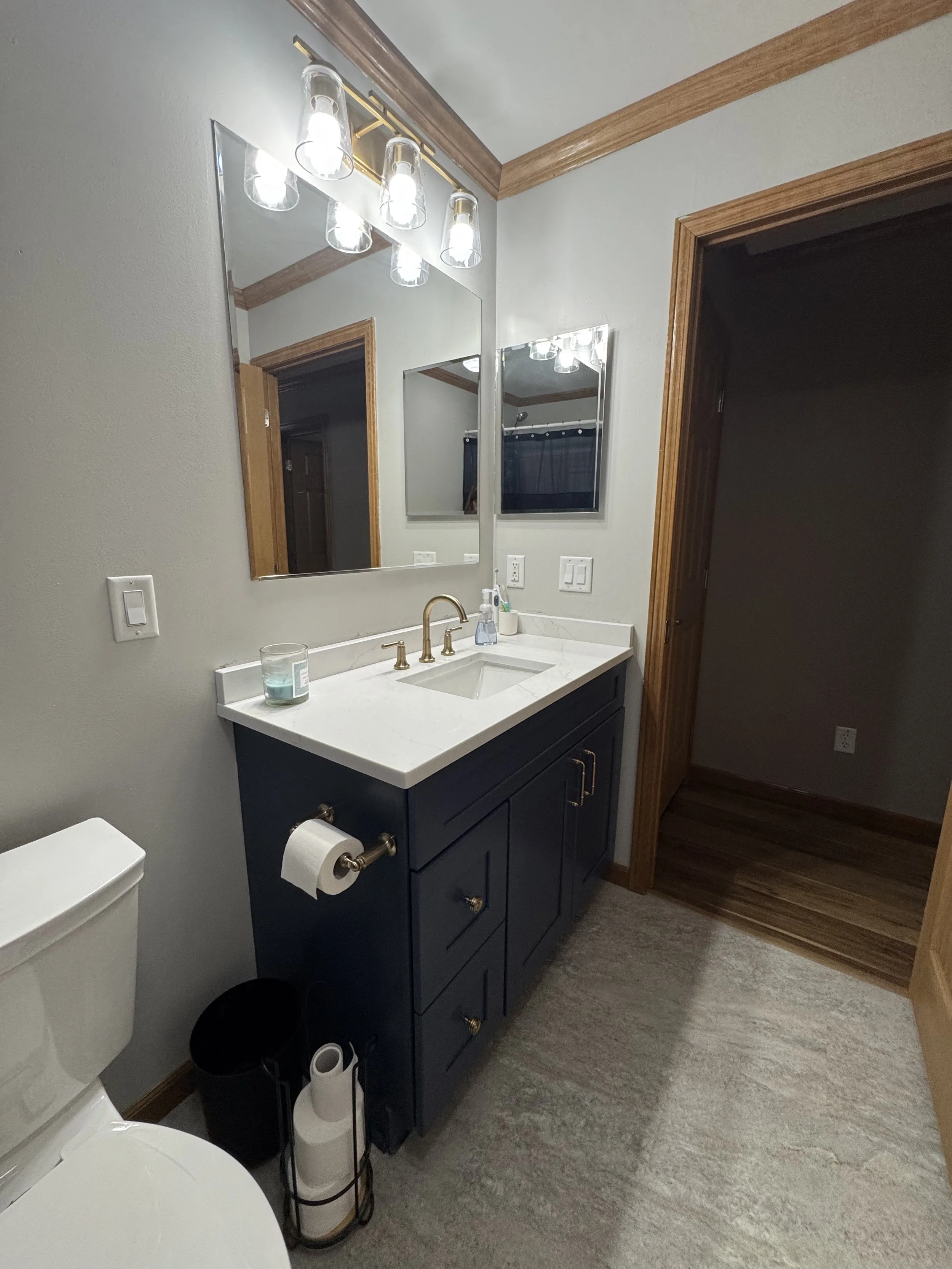 First Floor Remodel -Bathroom - Spring 2025 - Ocean Blue and White cabinetry, Shaw LVP flooring, MSI Quartz, Tile backsplash, Delta Touch Faucet Provenza Maxcore LVT Angel Trail flooring 