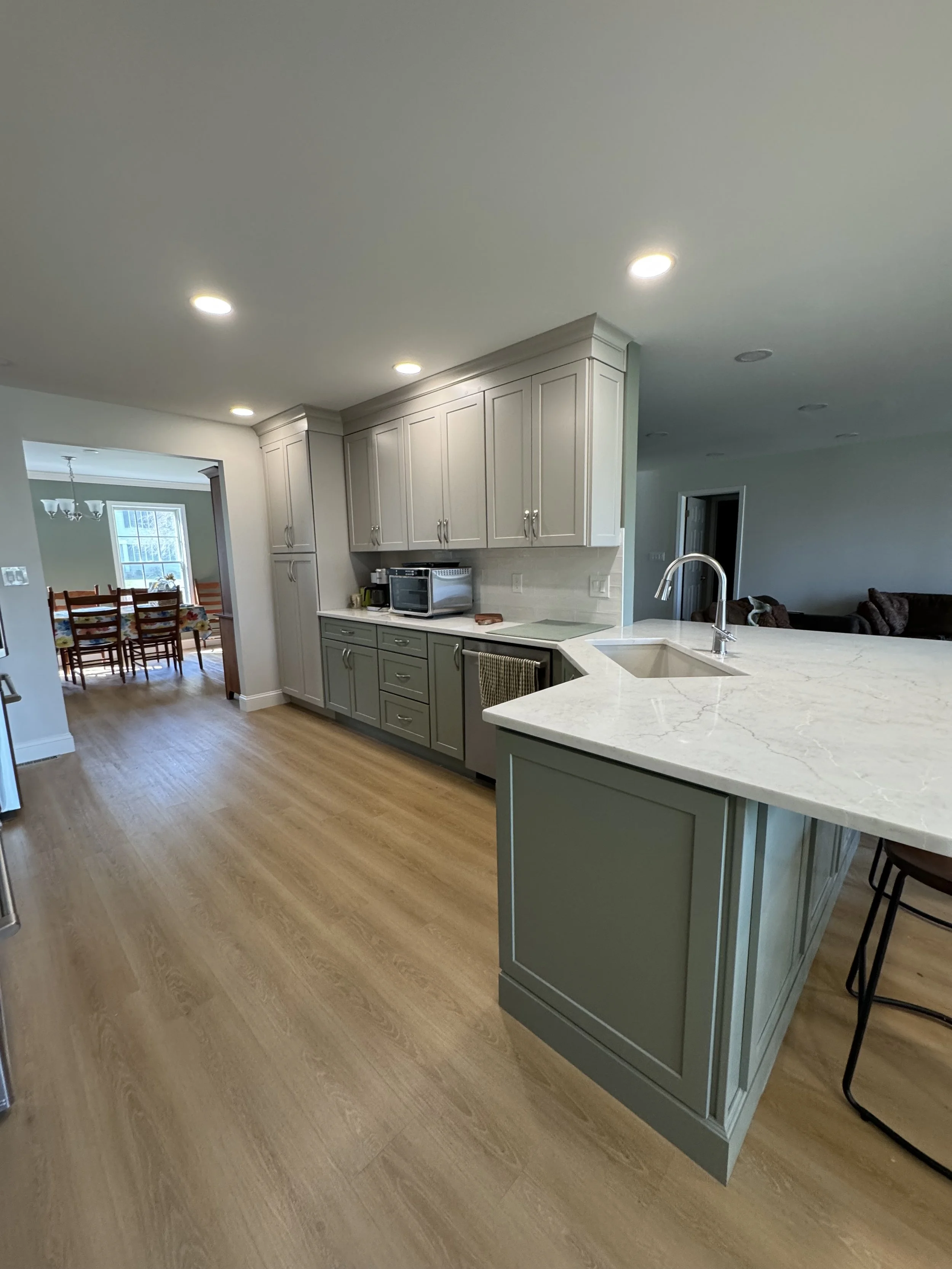 First Floor Remodel - Spring 2025 - Legend Cabinetry, Calacatta Miraggio Cove Quartz, Tile backsplash, MSI Valleyview Grove flooring