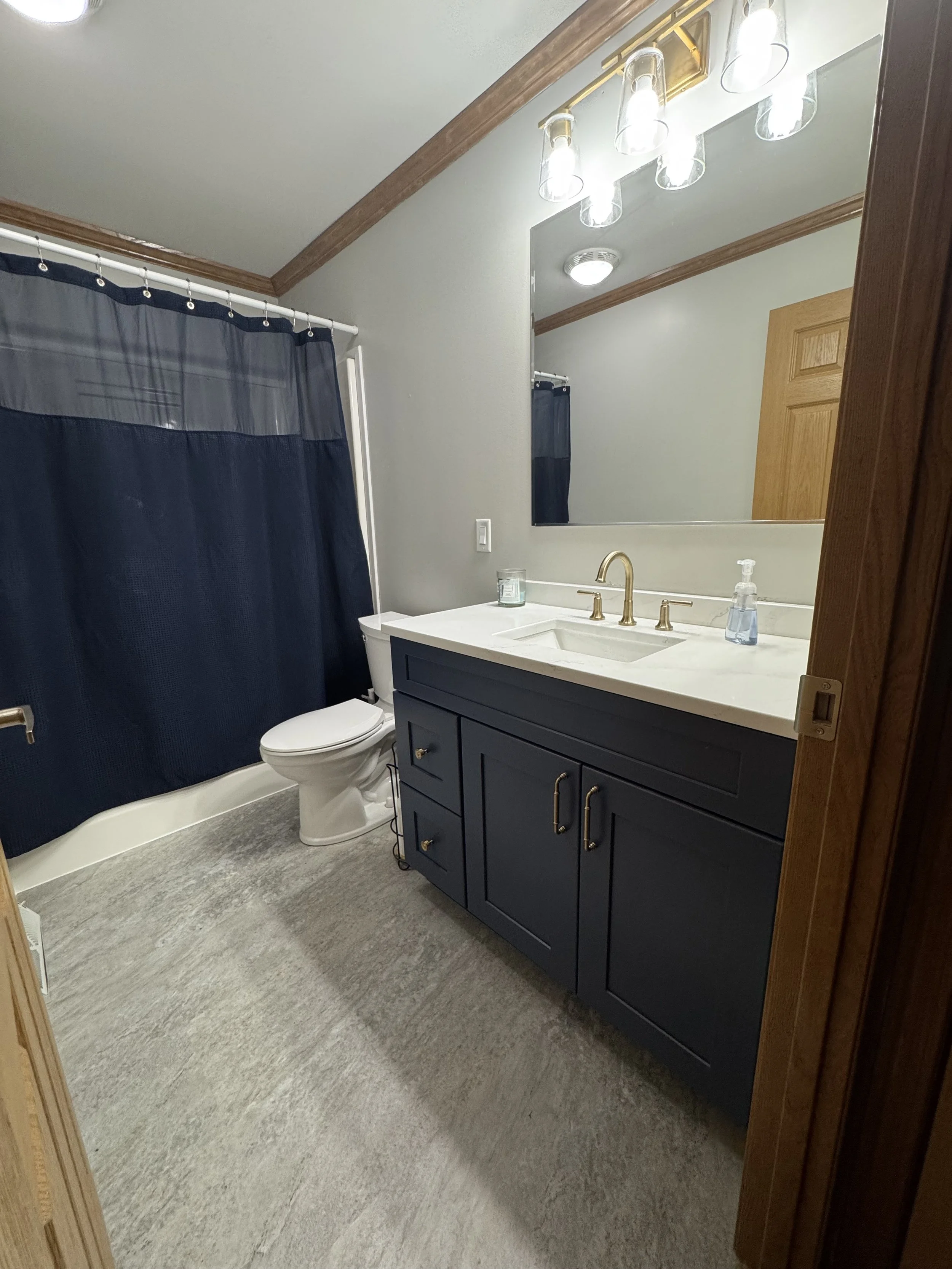 First Floor Remodel -Bathroom - Spring 2025 - Ocean Blue and White cabinetry, Shaw LVP flooring, MSI Quartz, Tile backsplash, Delta Touch Faucet