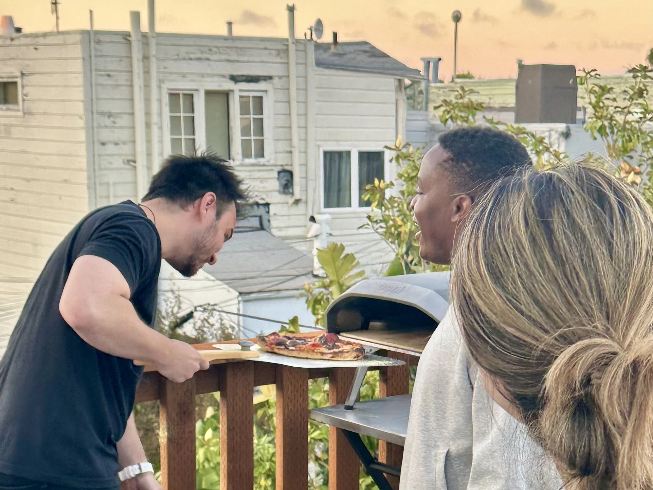 Danny sliding pizza into the Ooni oven