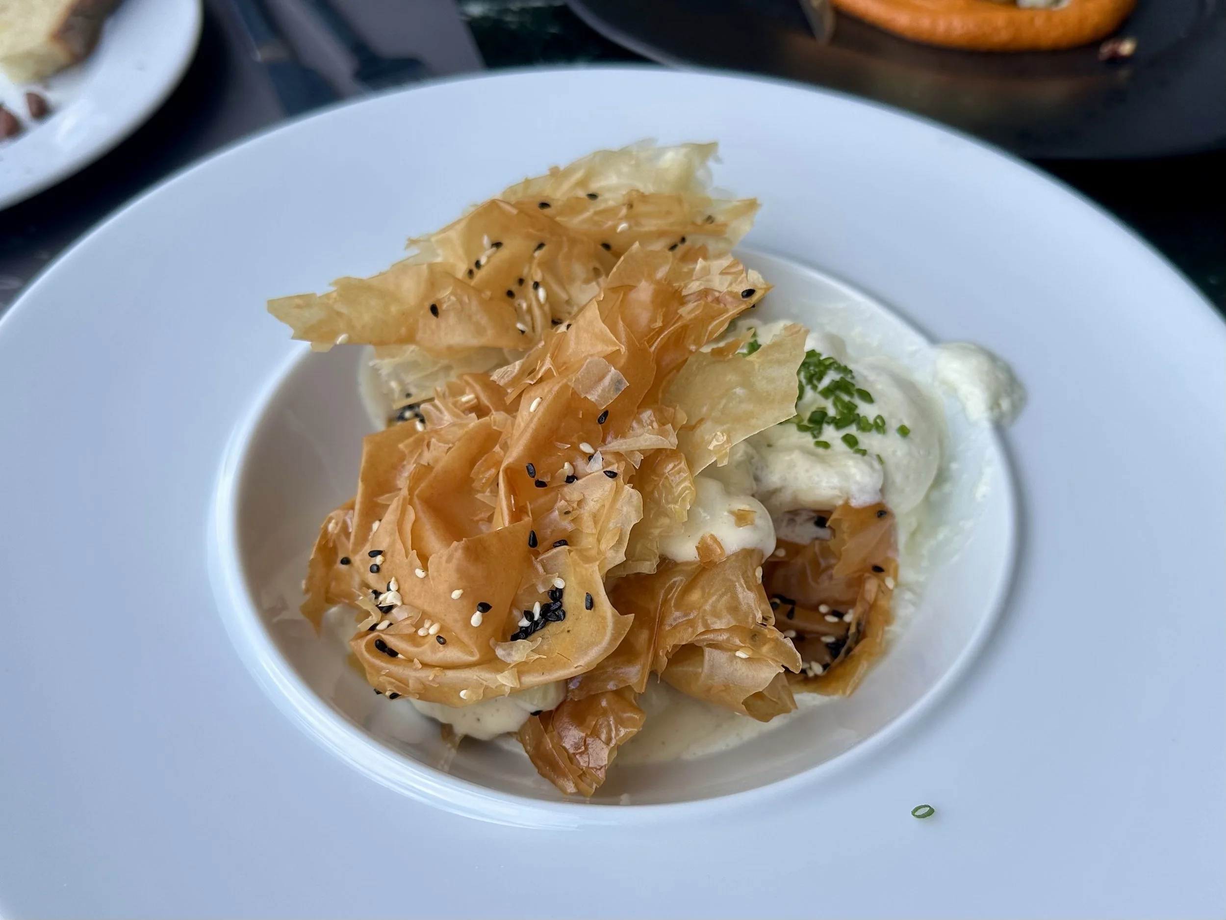 Cretan “Boureki” with pastry sheets, potatoes, zucchini, staka sauce and espuma of white cretan cheese