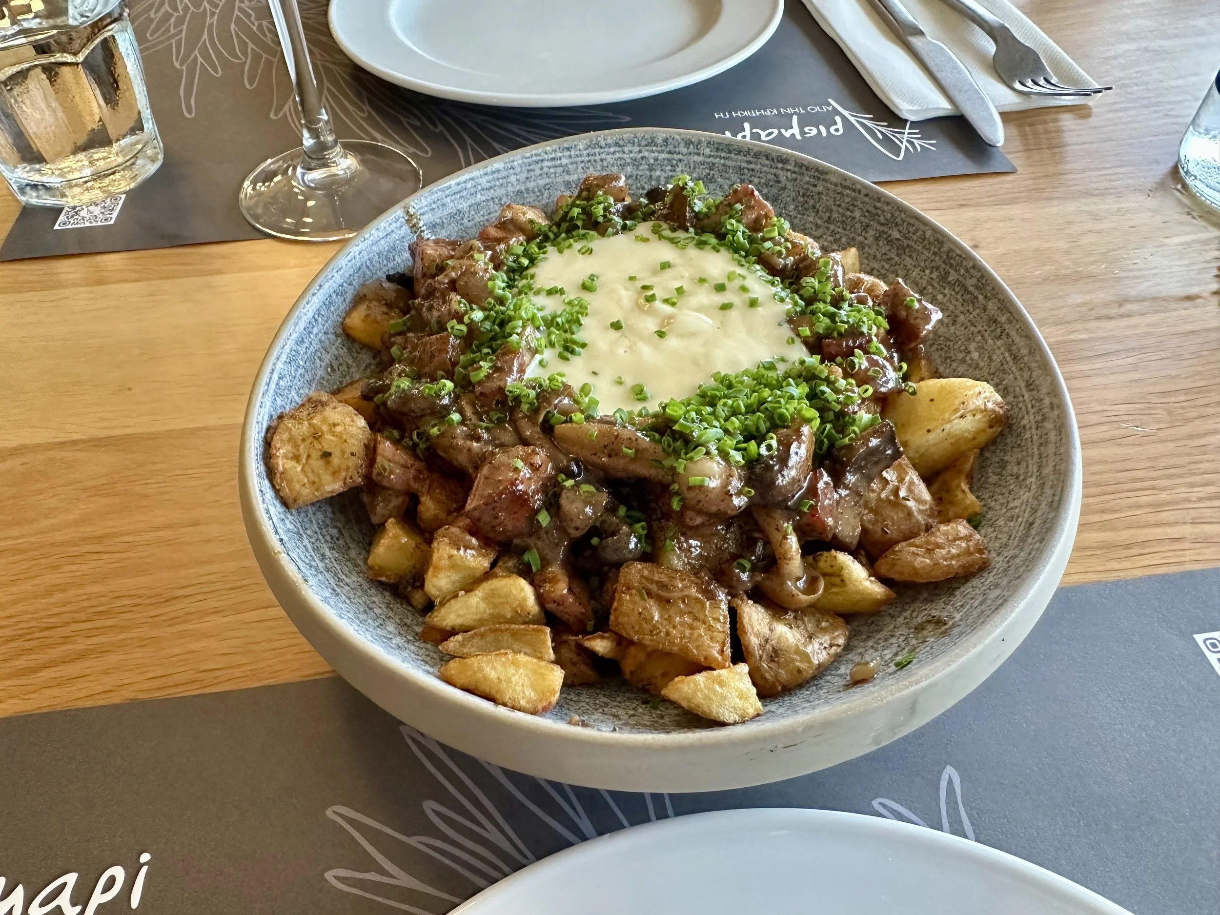 Cretan staka cream with potato, sauteed mushrooms, cretan smoked pork and poached egg