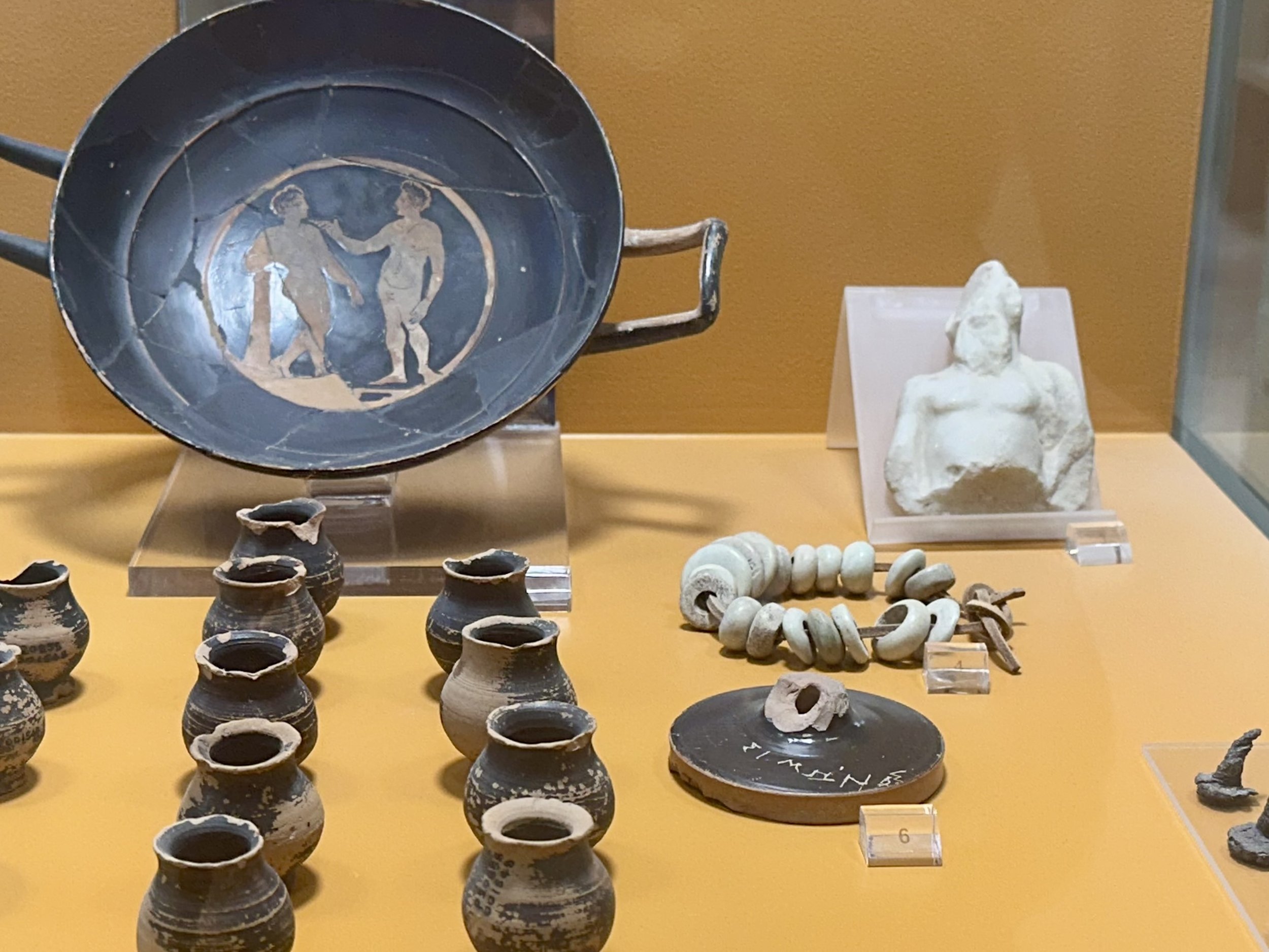 Objects from the jail, including a marble statuette of Socrates and medicine bottles perhaps used to hold hemlock for executions