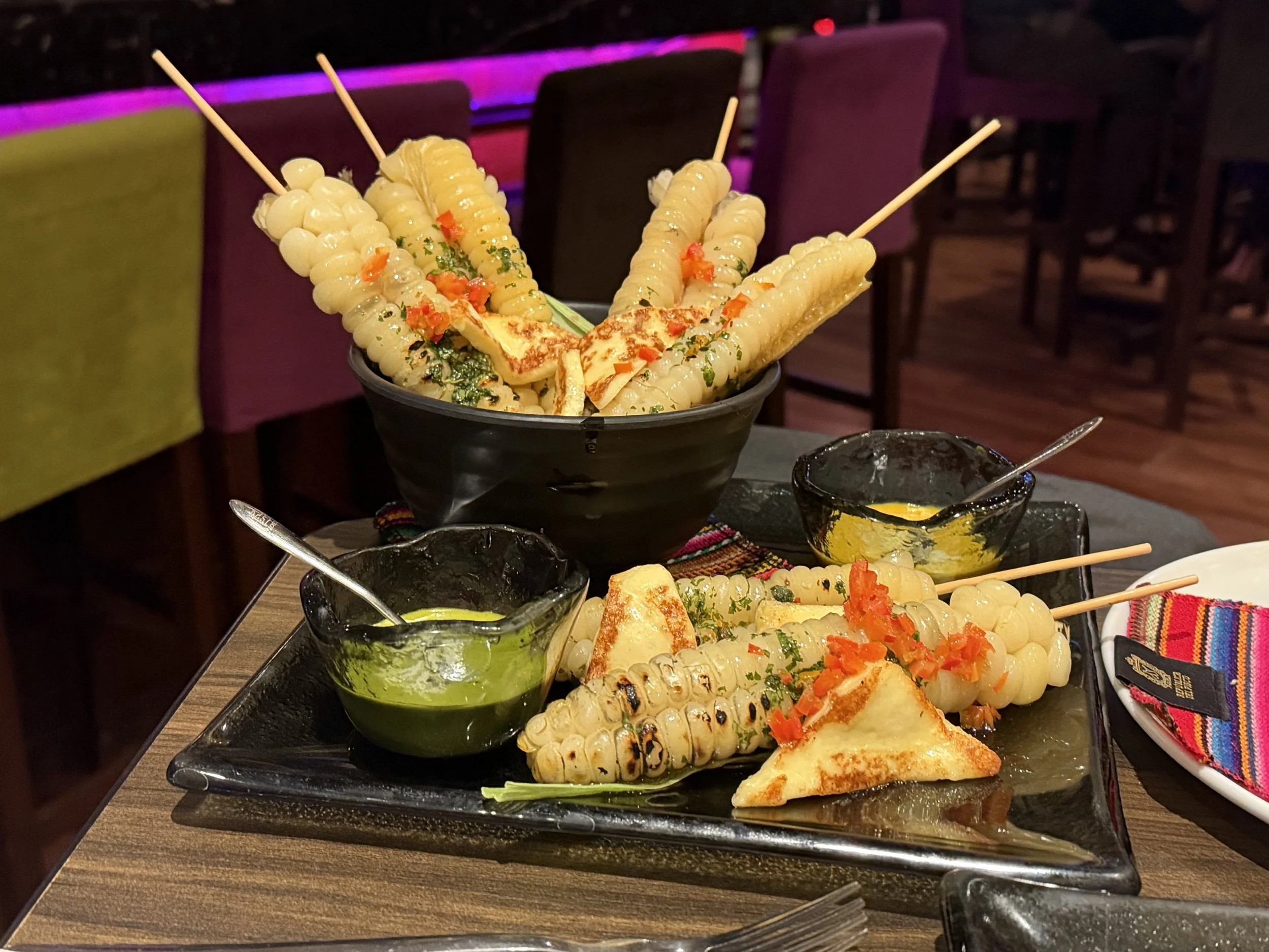  Tender corn, grilled and coated with butter and chimichurri, served with seared cheese, house-made ocopa, and huancaína sauces 