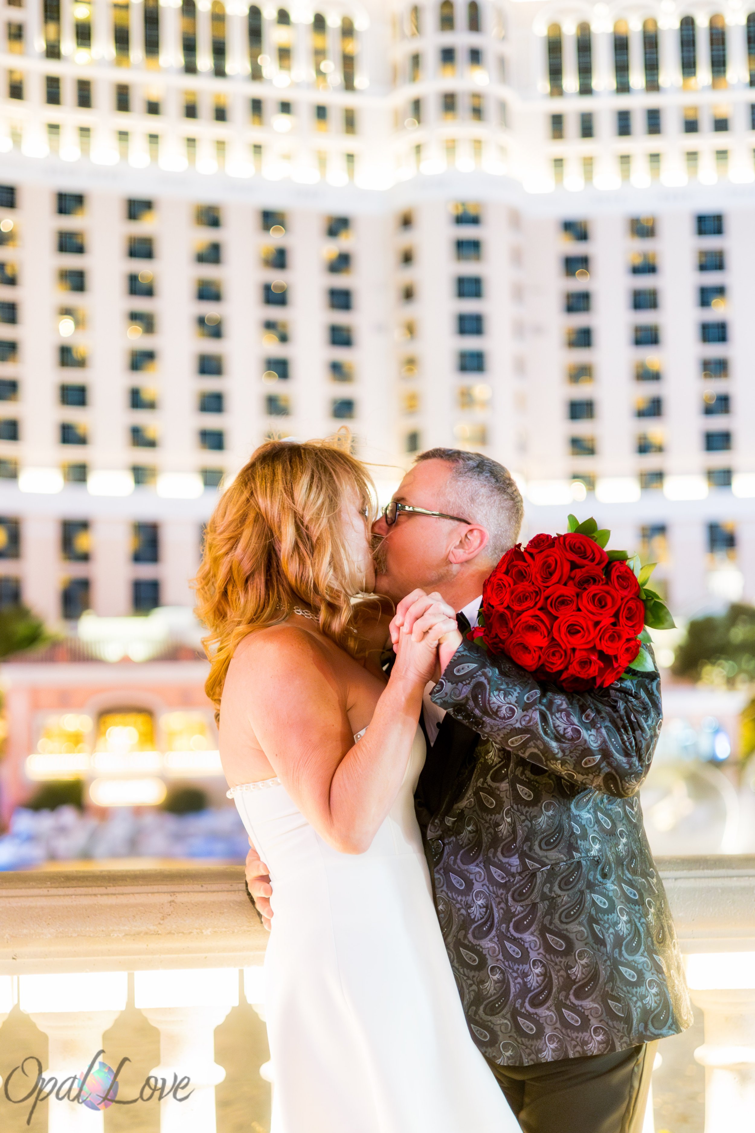 Bride and groom dancing in front of Bellagio at night after their Las Vegas wedding ceremony.