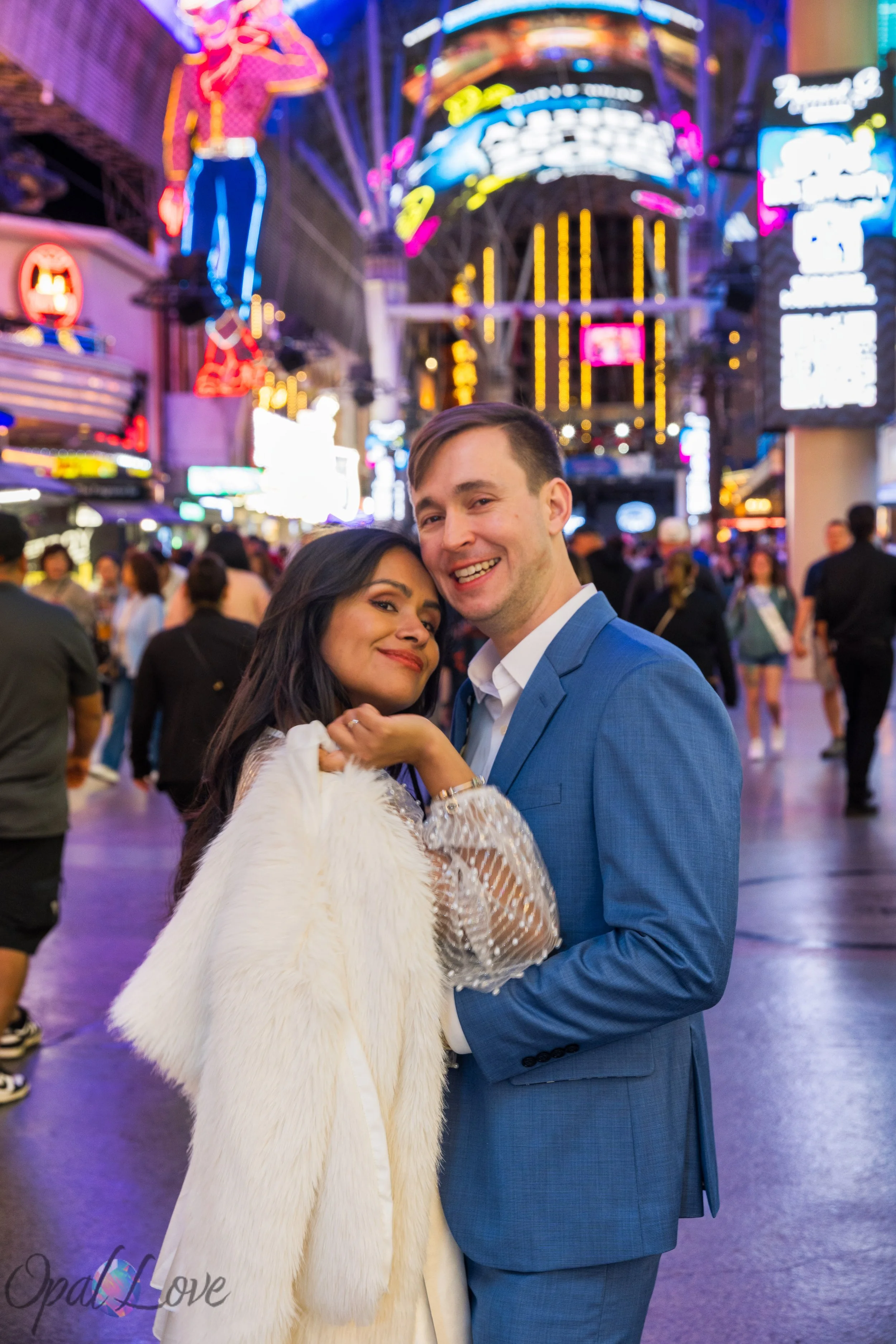 Couple posing with glowing lights wrapping around them on Fremont Street Experience