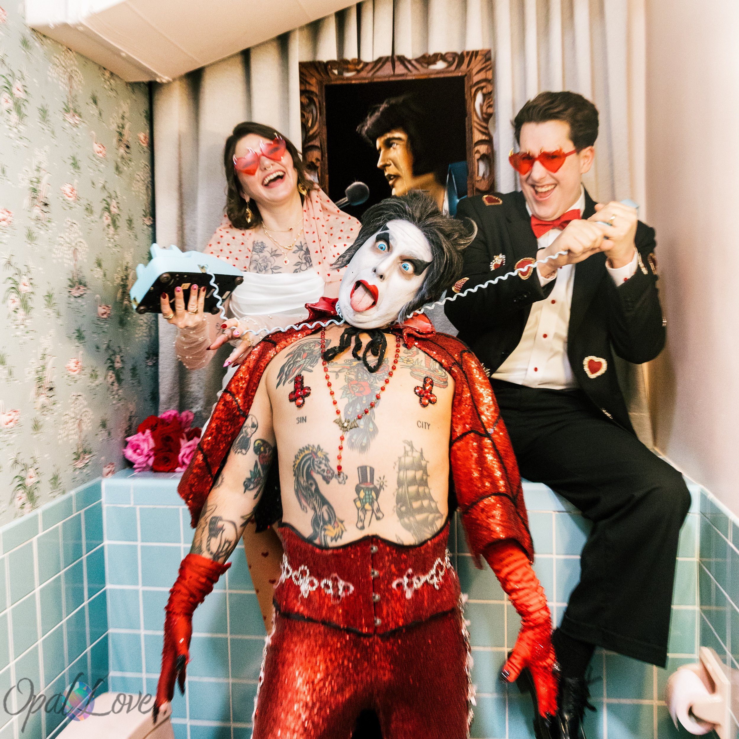 Rachel and Tom take a playful wedding portrait with Hellvis in the retro bathroom at A Sure Thing Wedding Chapel in Las Vegas.