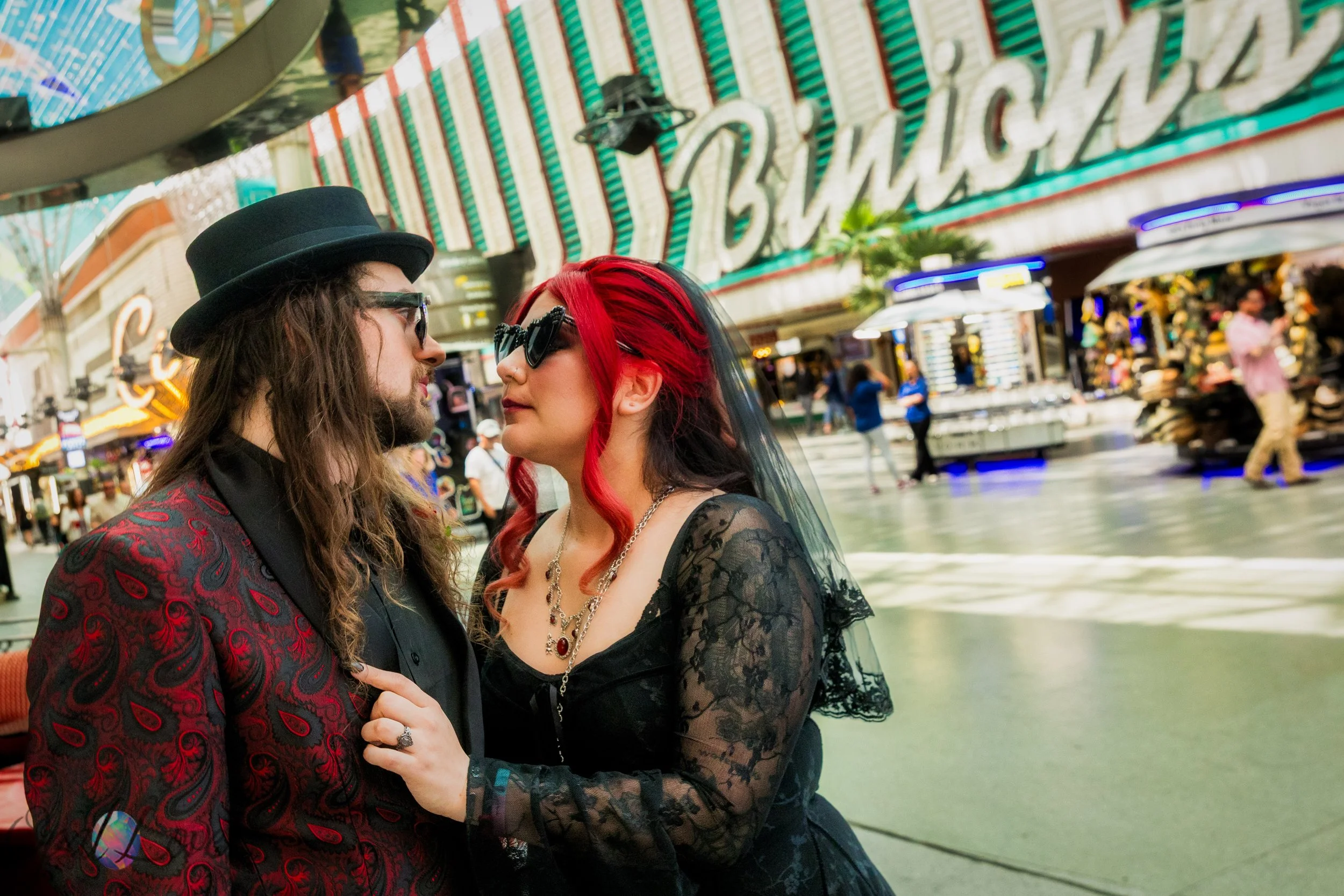 Wedding couple posing beneath the Binion’s sign on Fremont Street in Las Vegas