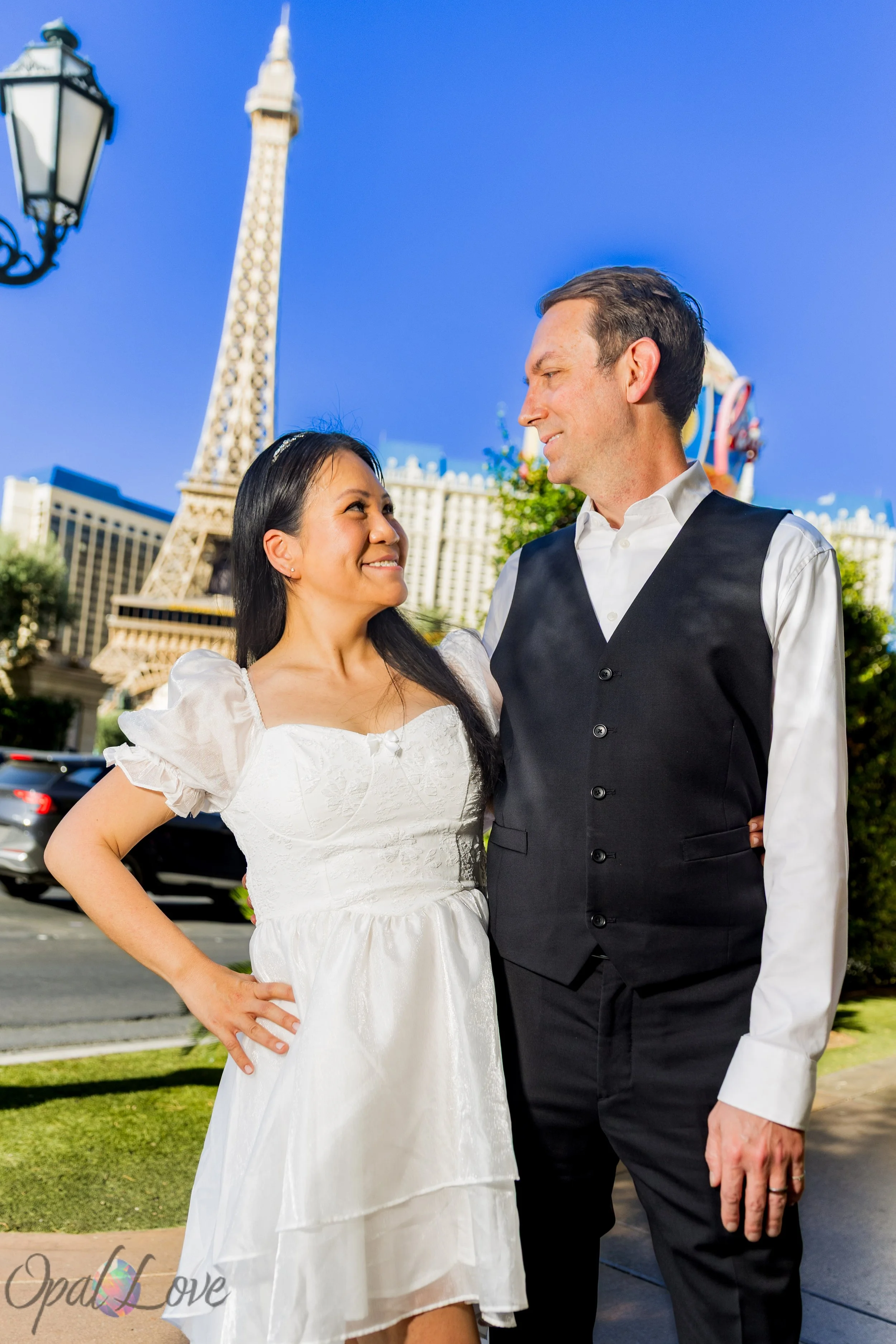 Newlyweds posing together near Paris Las Vegas and the Eiffel Tower on the Las Vegas Strip