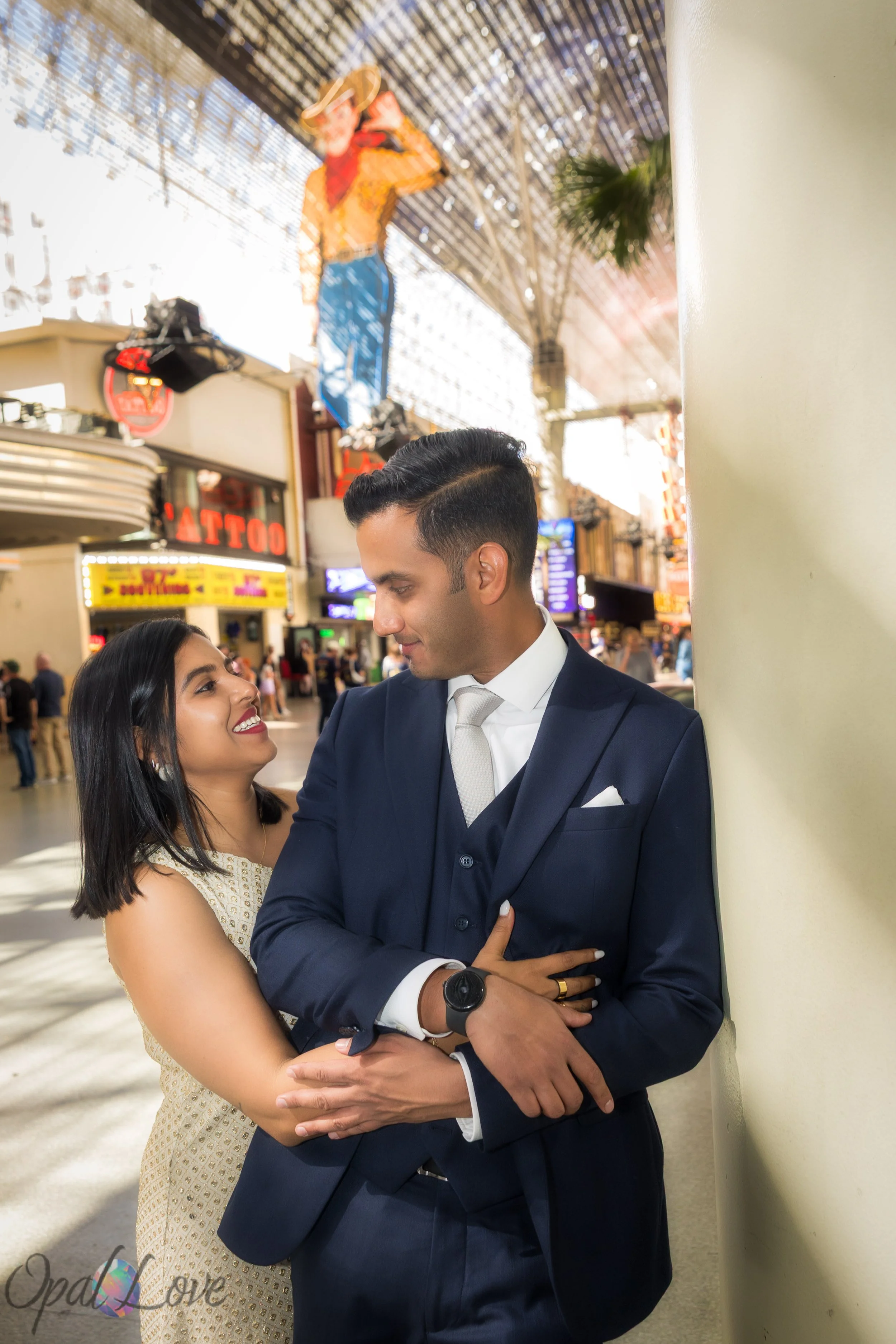 Groom dipping bride under Vegas Vic during their wedding photos.