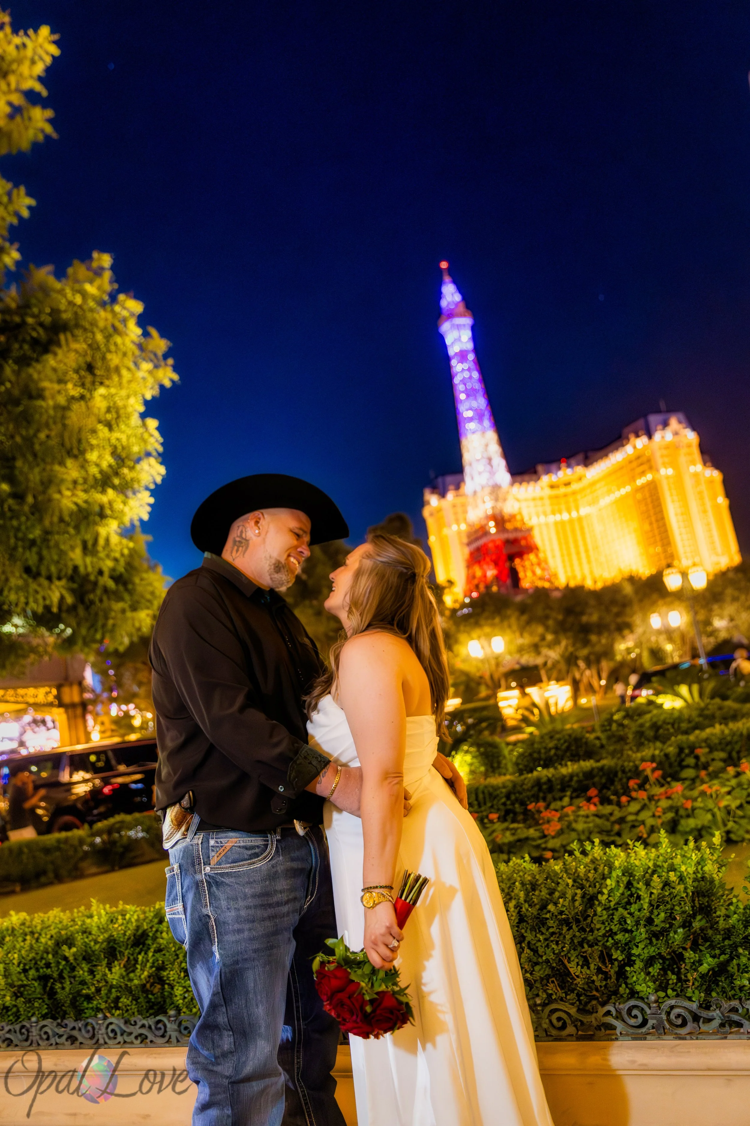 Couple embracing overlooking Bellagio at night on the Las Vegas Strip