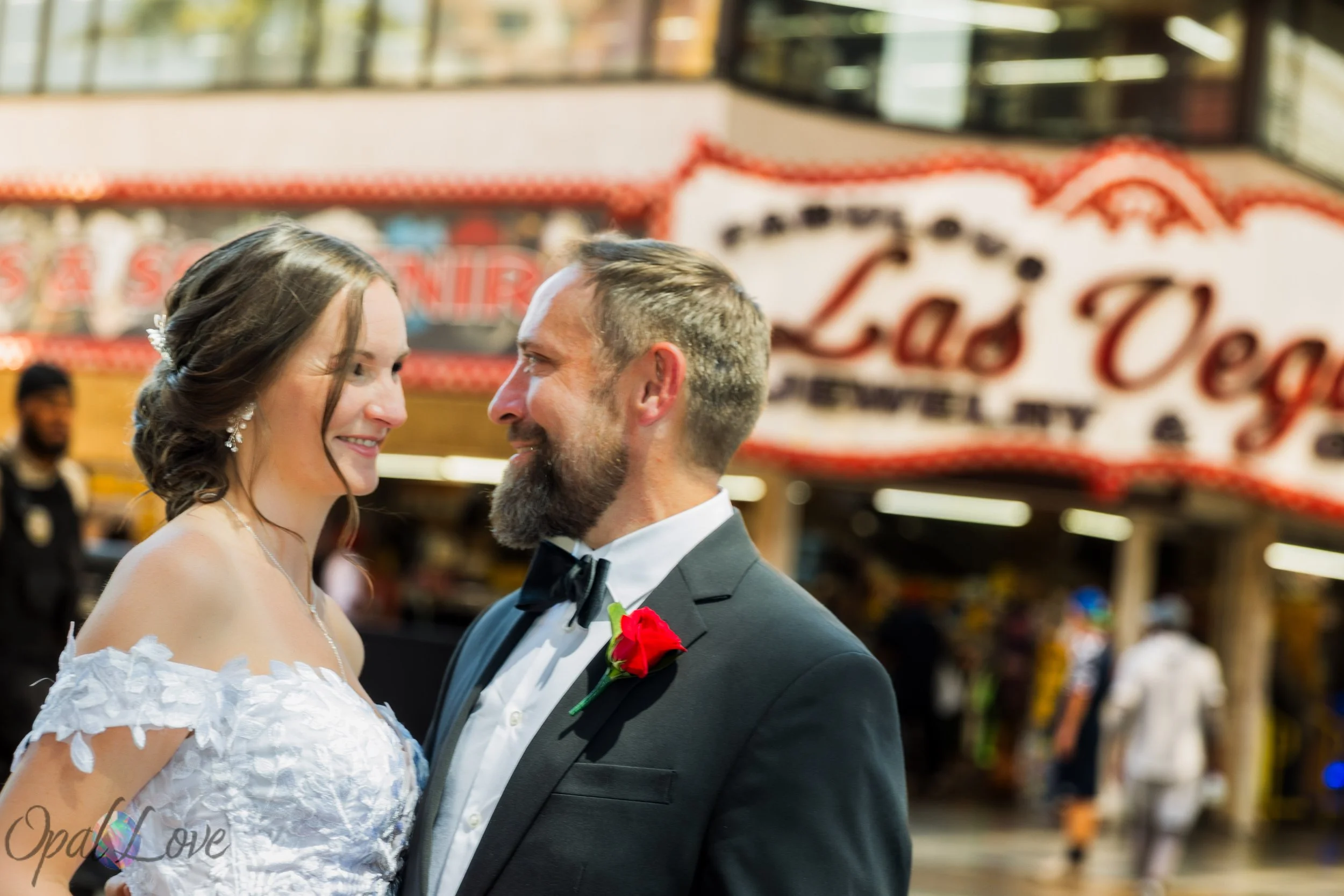 Kari and Rickie together in front of classic Las Vegas casino signage during their Fremont Street wedding photo session.