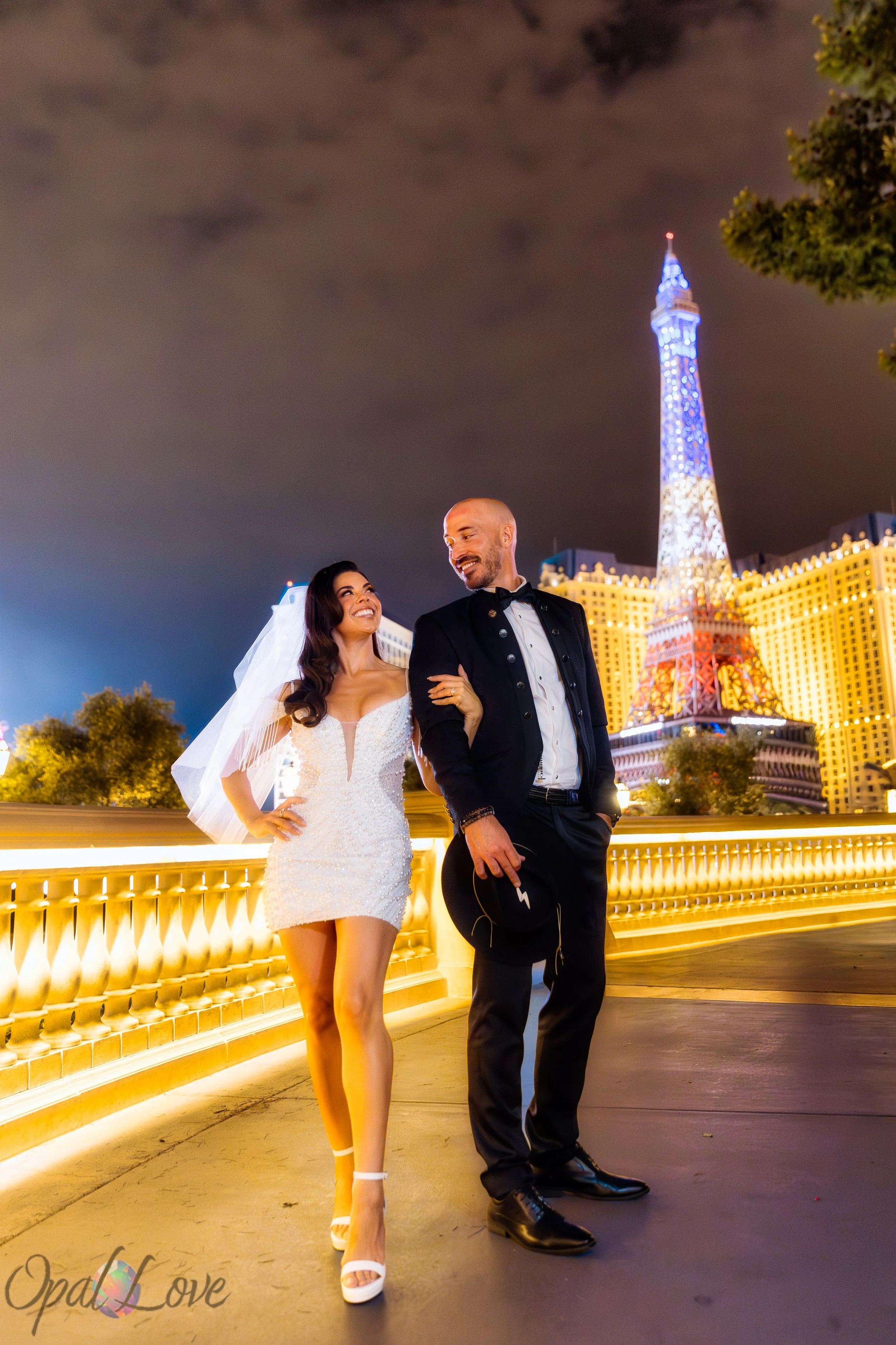 Bride and groom laughing together at Bellagio fountains Las Vegas Strip