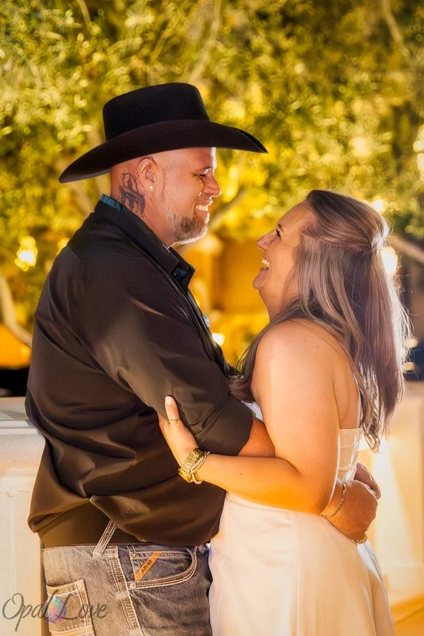 Couple smiling at each other while embracing at Bellagio in Las Vegas.
