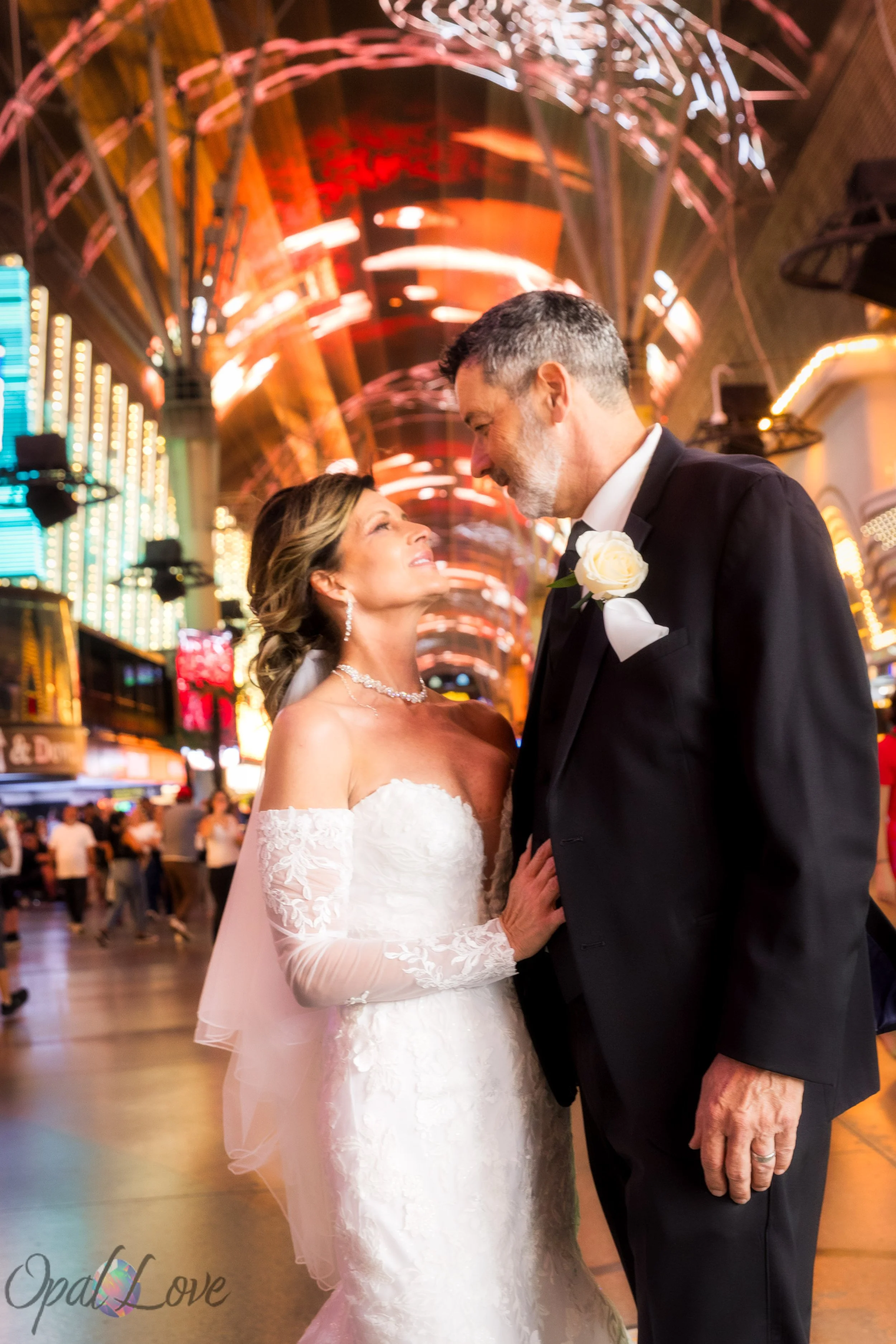 Couple under Fremont Street neon lights during Las Vegas elopement