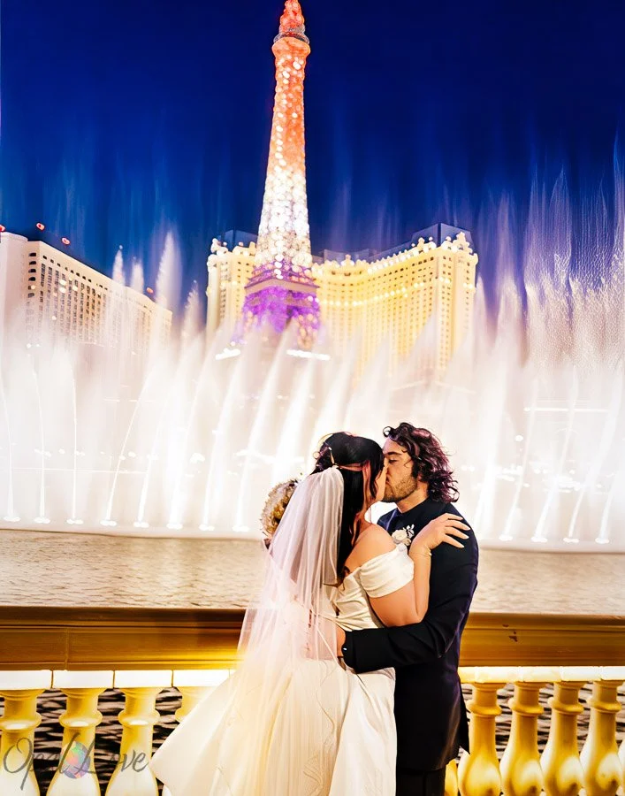 Newlywed couple kissing in front of the Bellagio fountains with the Eiffel Tower in the background.