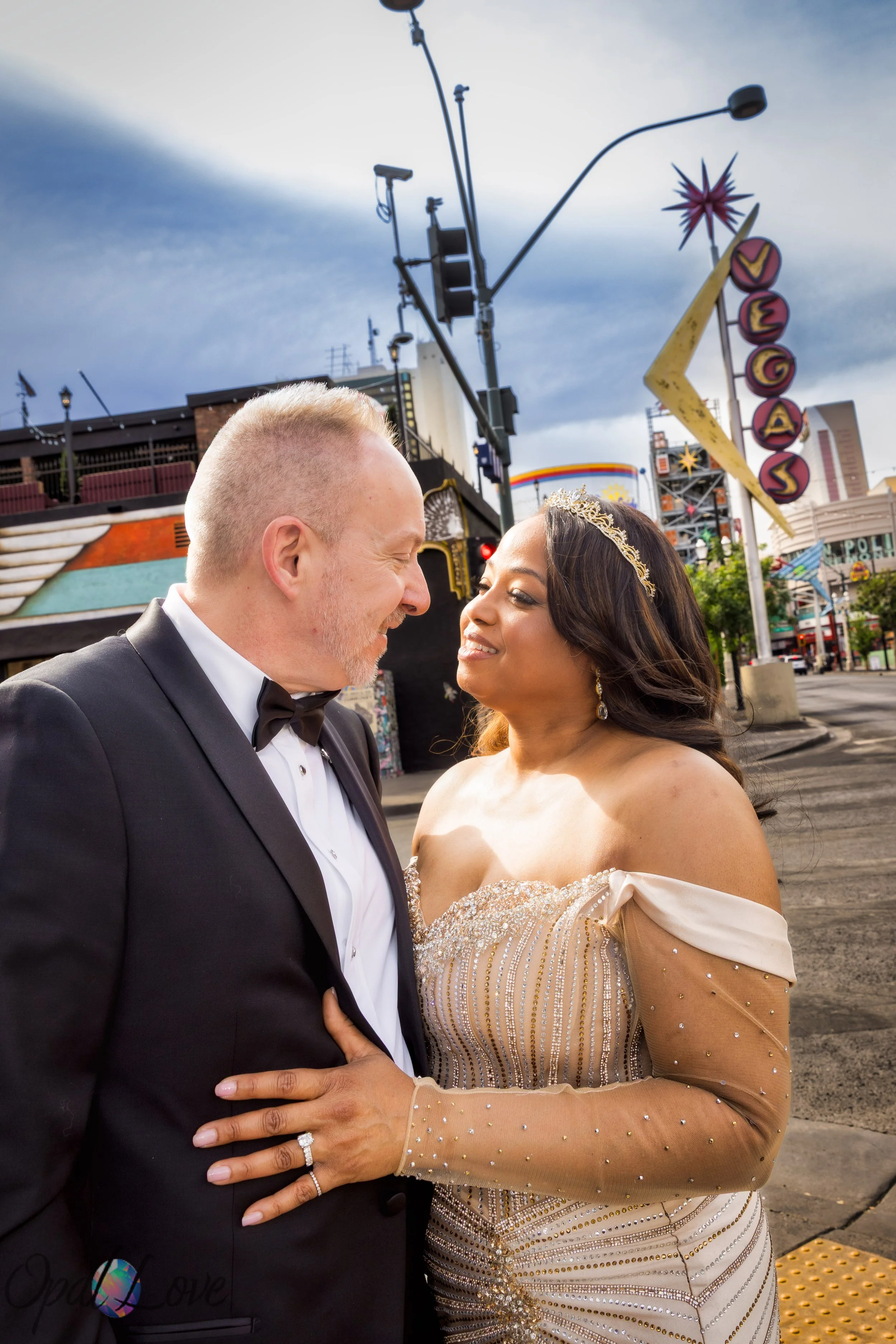 Couple posing near Vegas sign on Fremont Street in Downtown Las Vegas