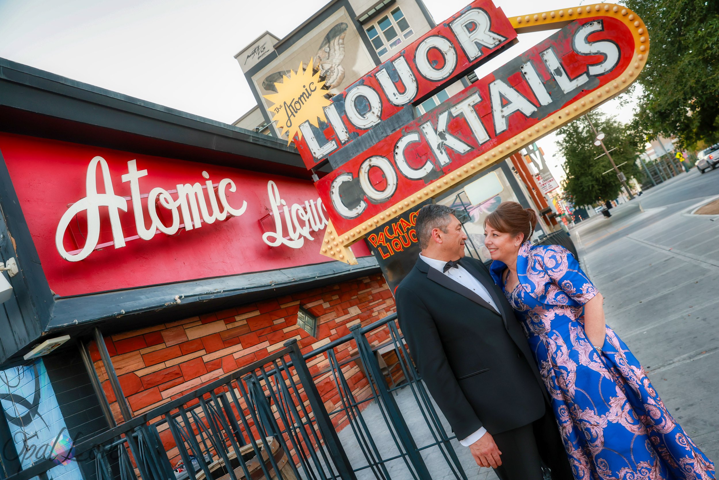 Couple smiling at each other outside Atomic Liquors in downtown Las Vegas.