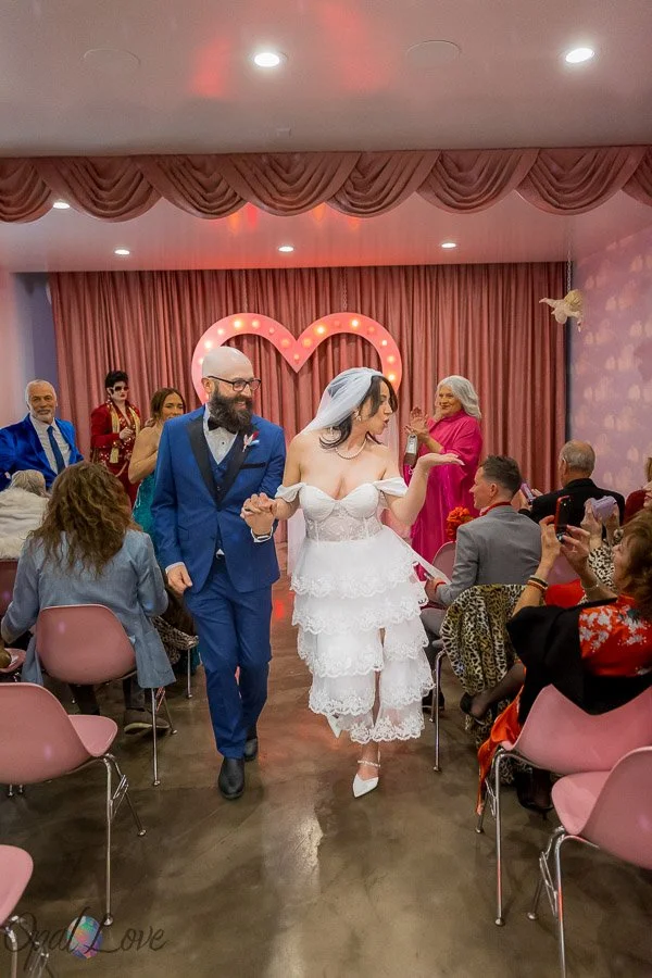 Newlywed couple walking down the aisle after their ceremony at Sure Thing Chapel in Las Vegas.